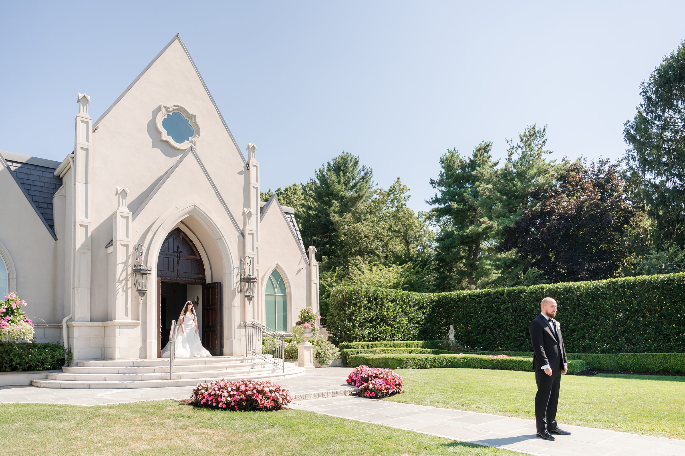 landscape picture of bride in entrance chapel distance from the groom, groom facing against the bride