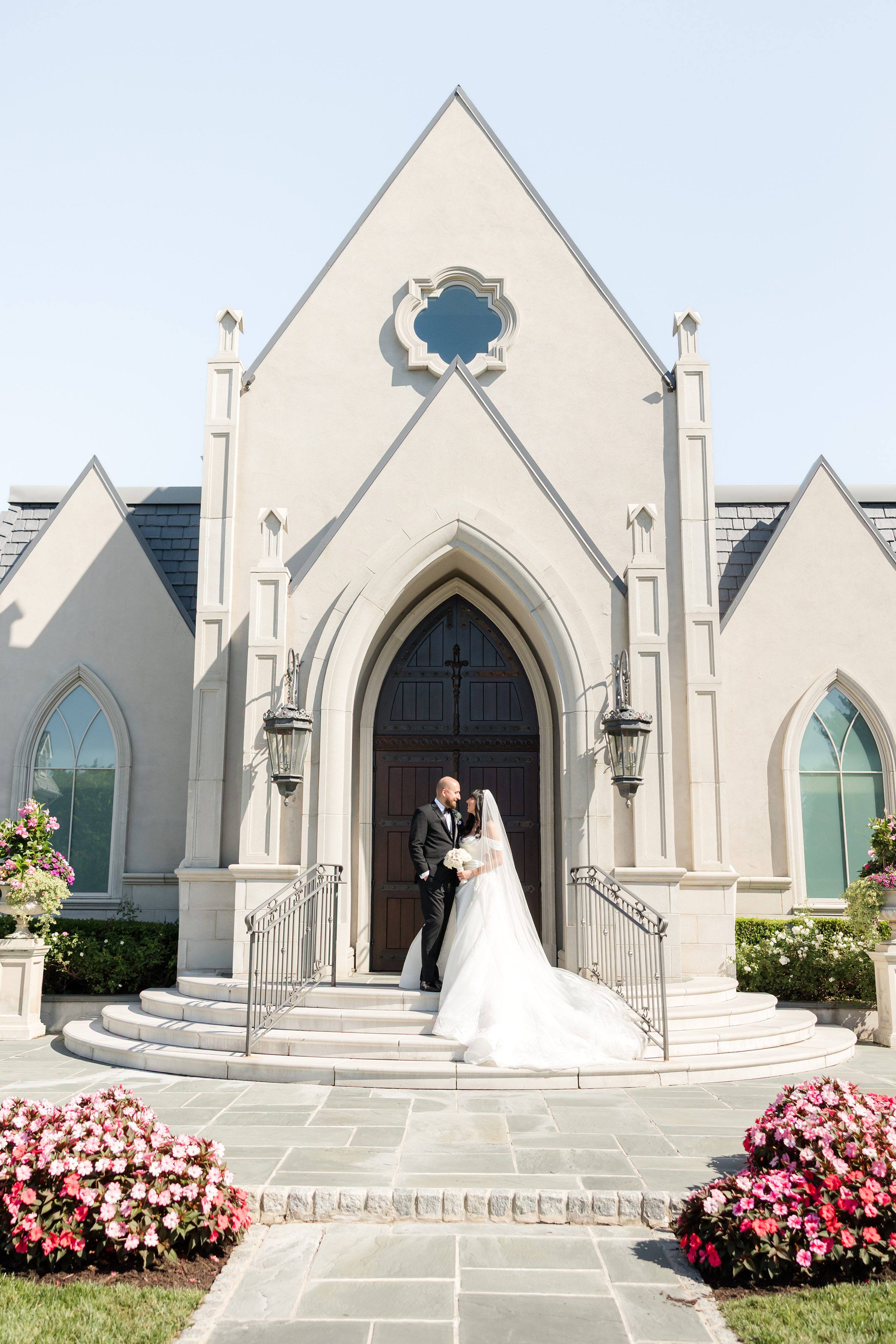 potrait picture of bride and groom standing at the entrance chapel 