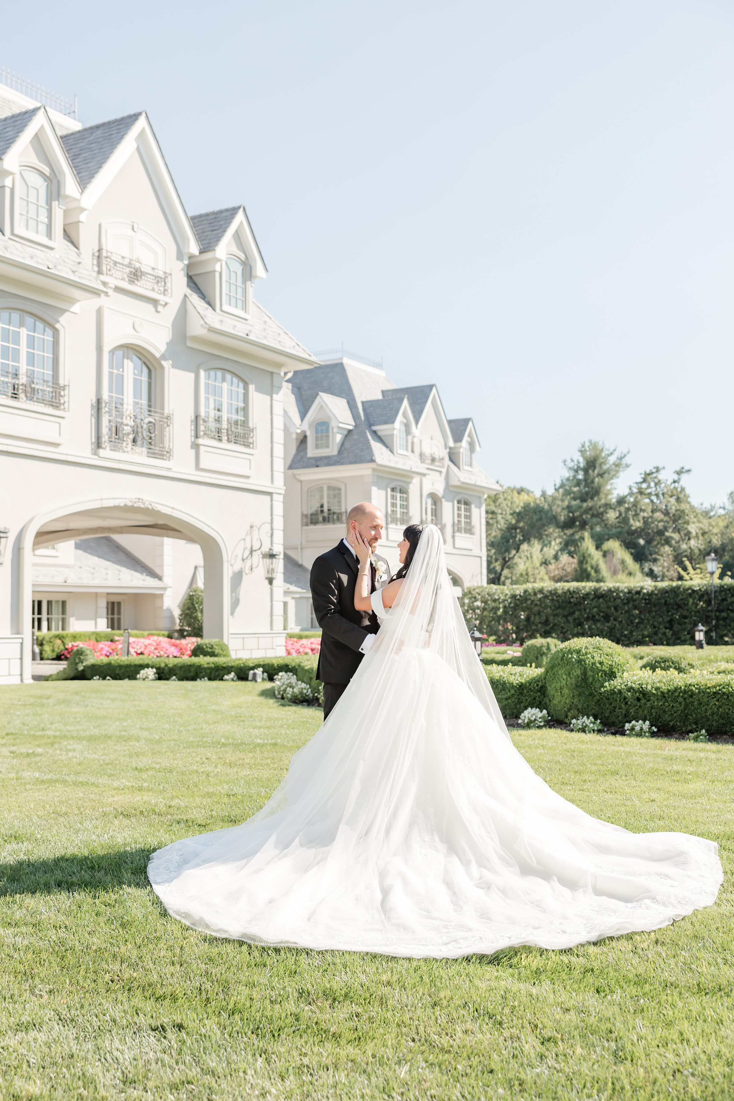 bride touching groom's face at Park Chateau Estate lawn