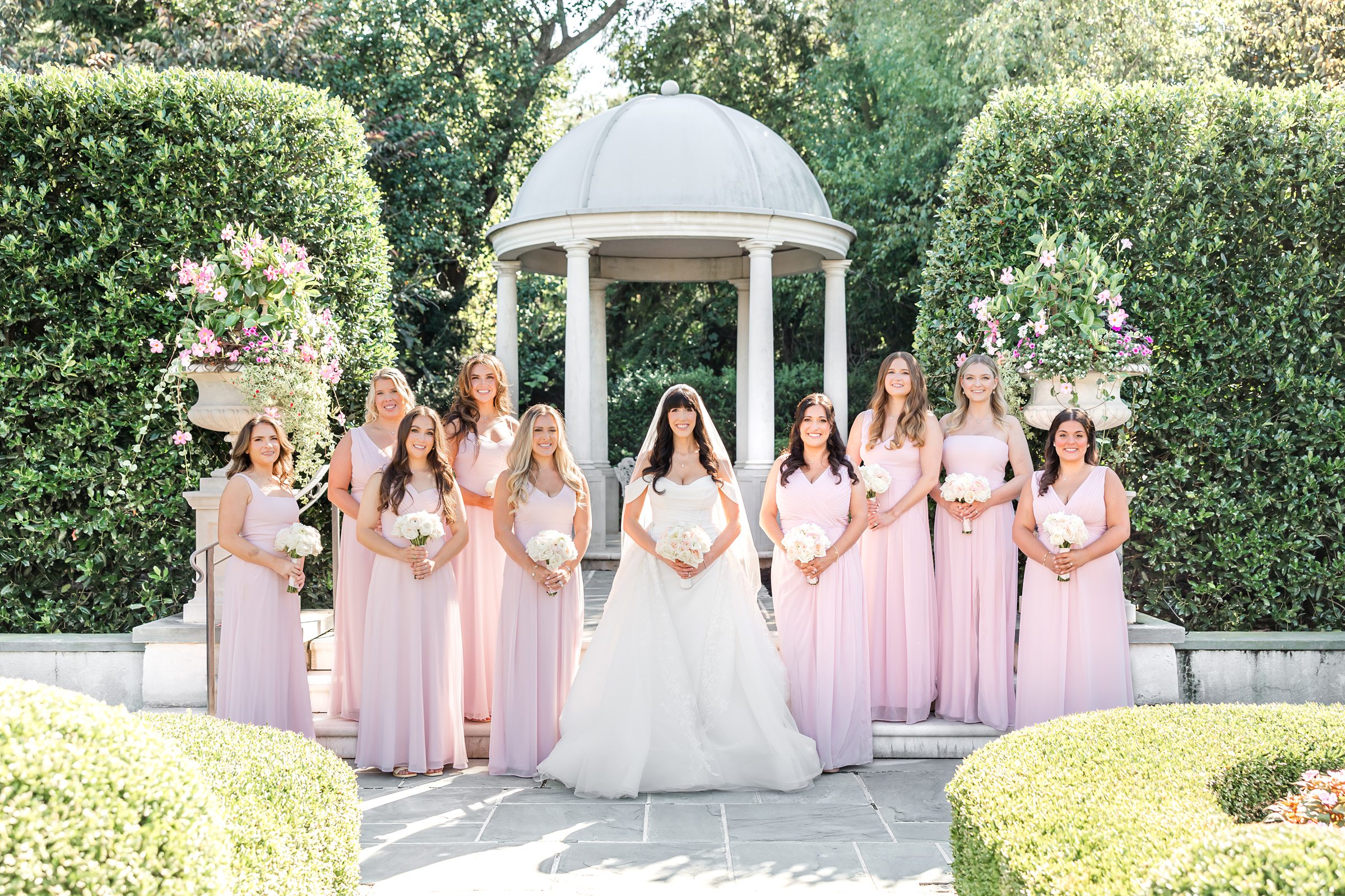 landscape photo at the gazebo, bride standing in the middle of bridesmaids