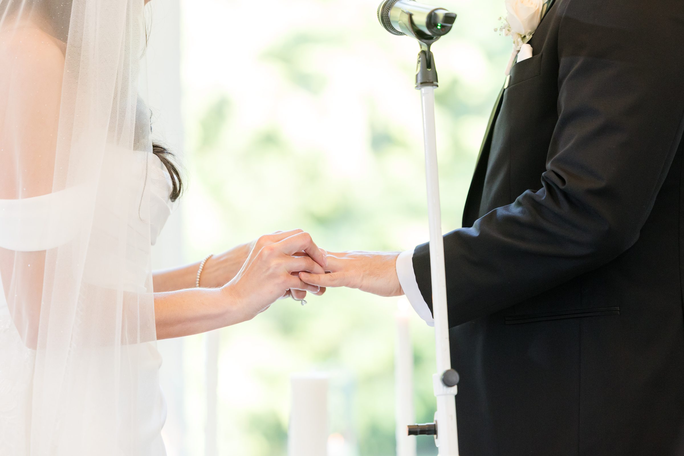a close-up shot of bride and groom's hands