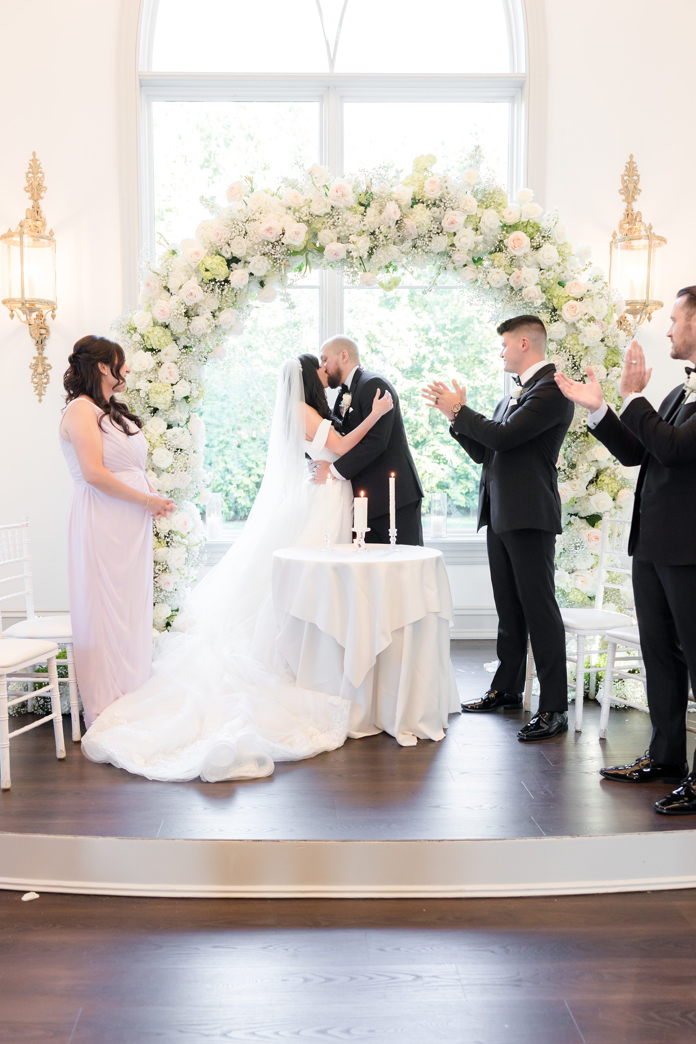 bride and groom kissing at each other at the altar