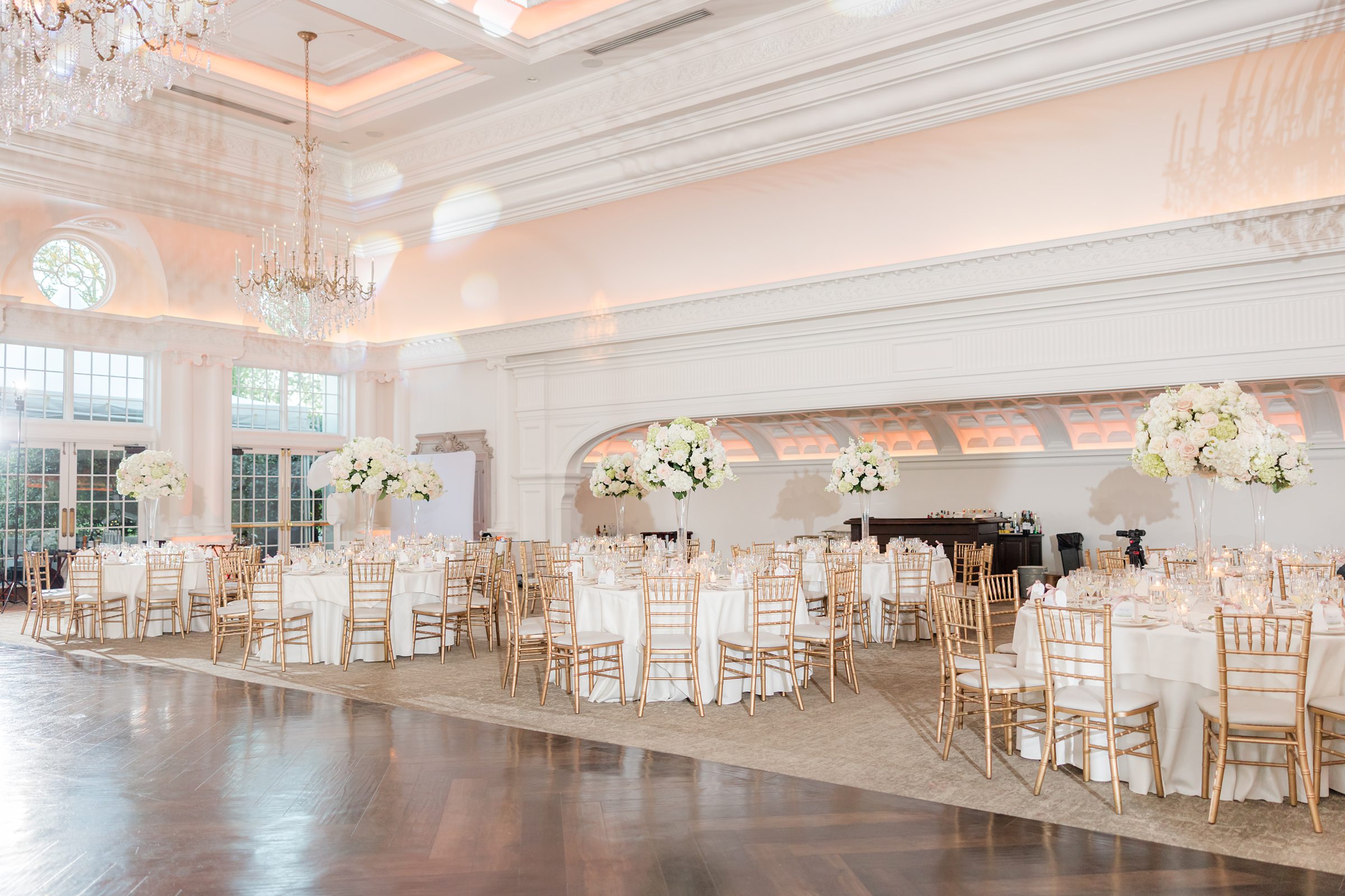 Empty decorated ballroom of Park Chateau Estate, focusing on white florals