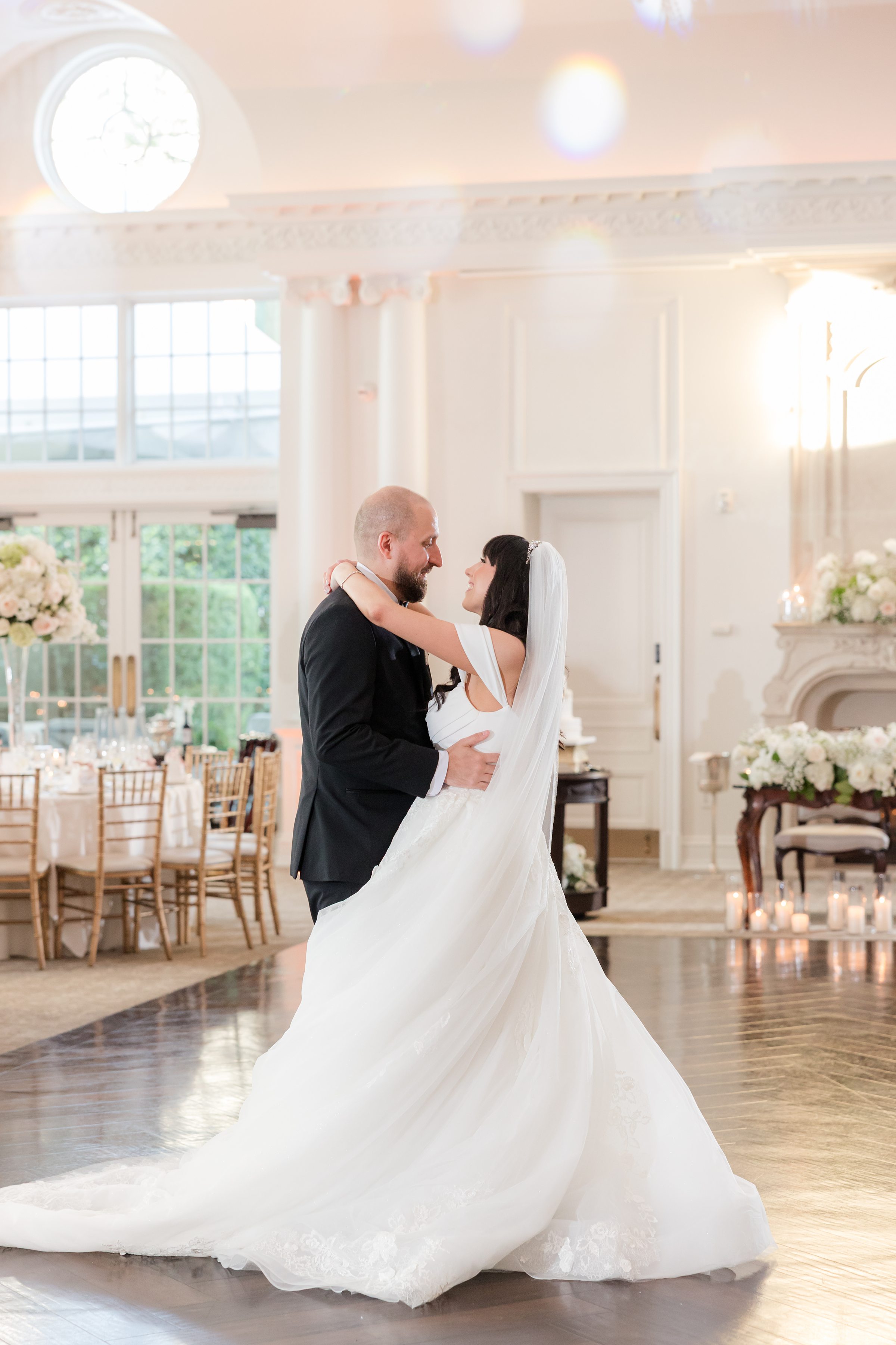 Photo of bride and groom looking at each other intimately while dancing