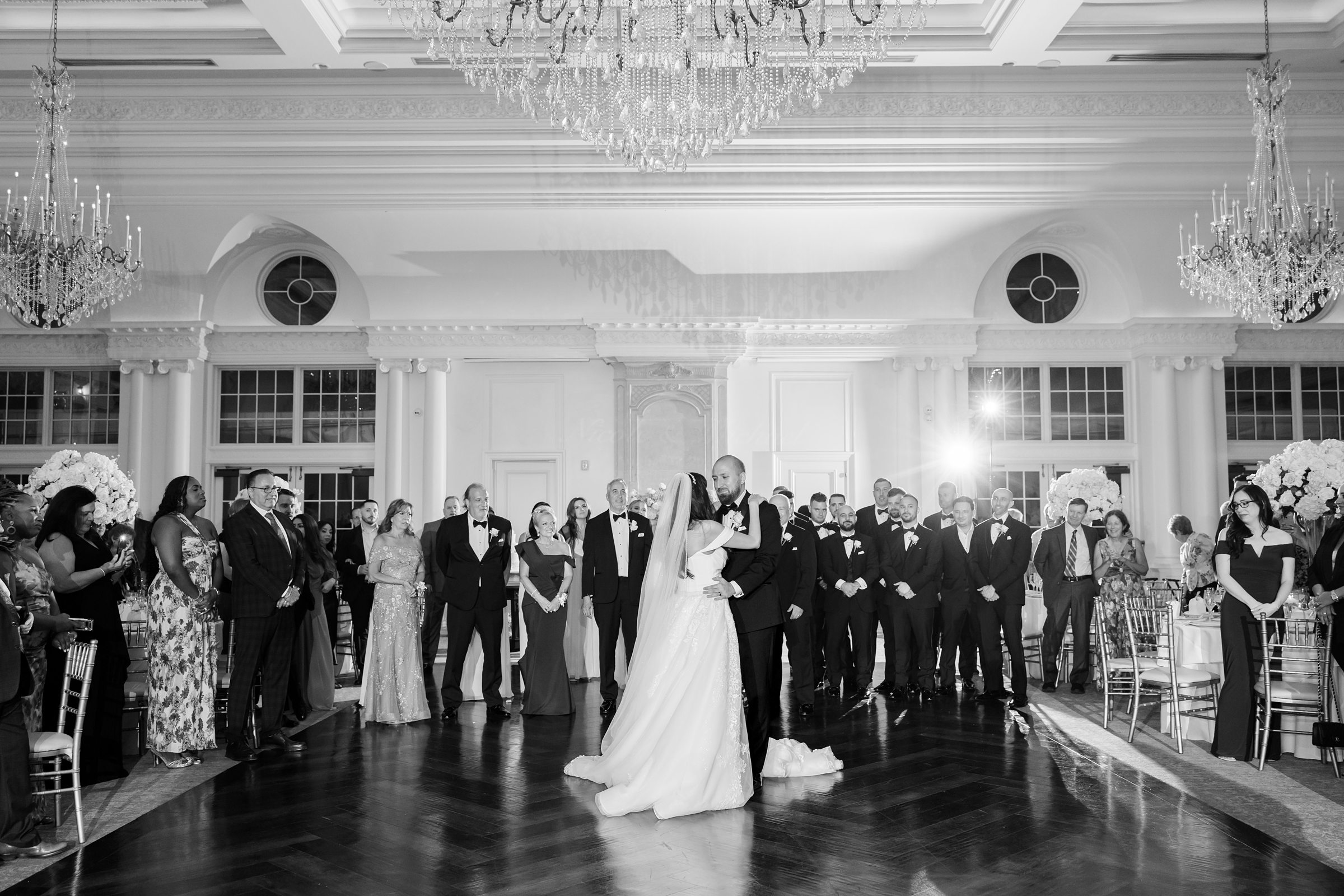 black and white landscape of the couple's first dance, with their guests surrounding them on the dance floor
