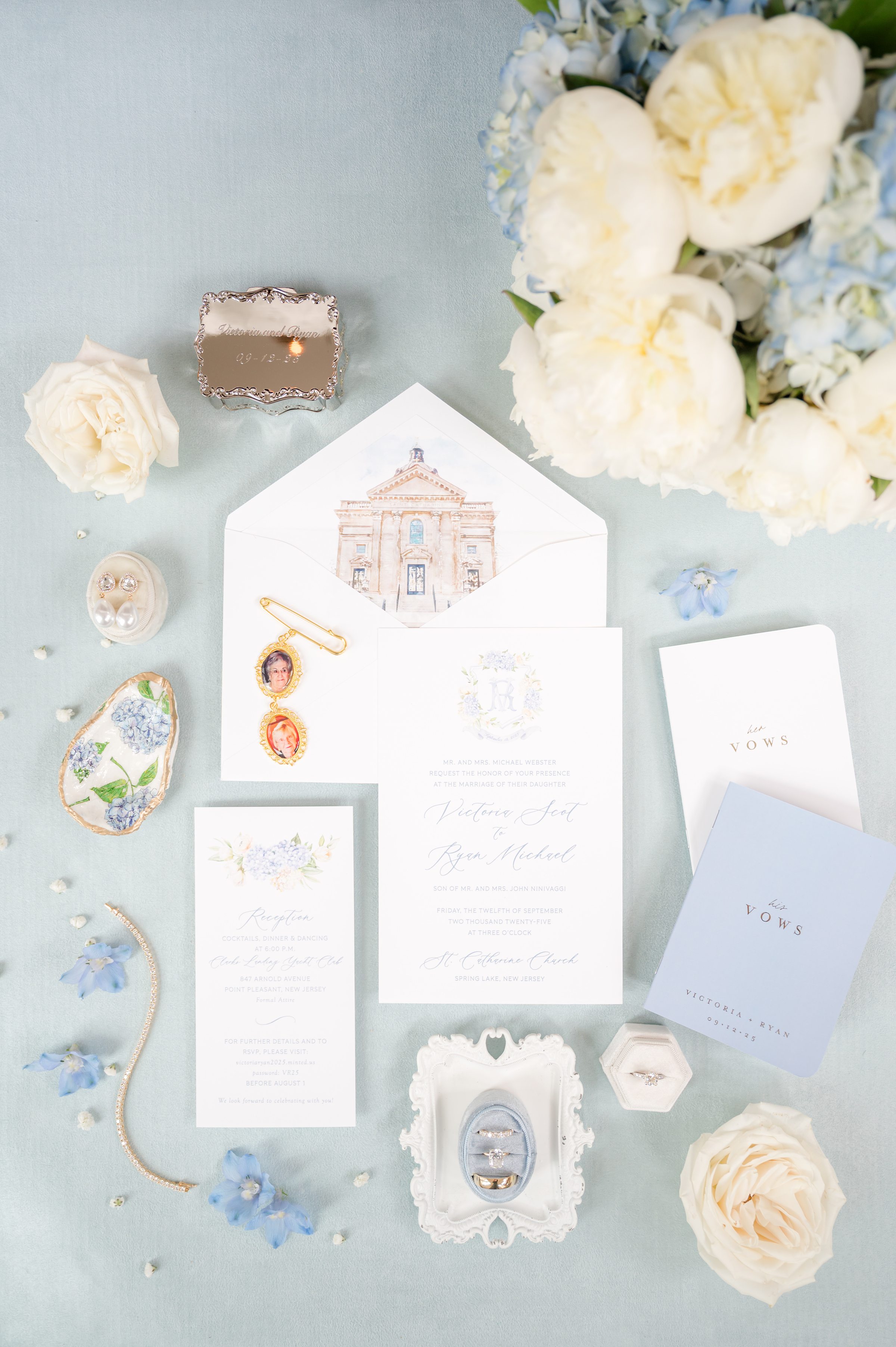 Elegant wedding stationery surrounded by rings, soft blooms, and cherished keepsakes, telling the story of a love thoughtfully prepared and beautifully celebrated.