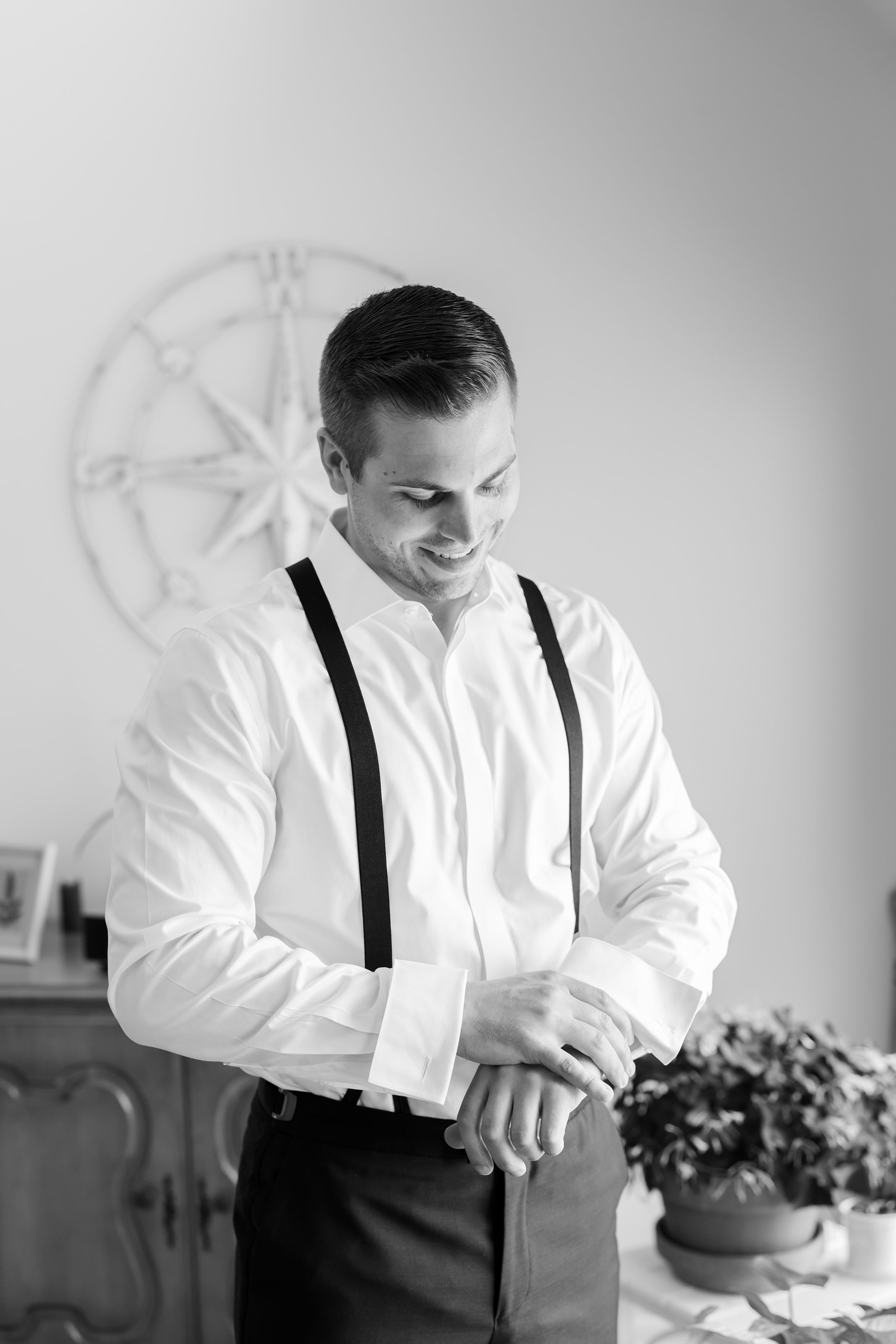 A quiet moment of preparation—the groom adjusts his cuff, reflecting on the love and commitment awaiting him