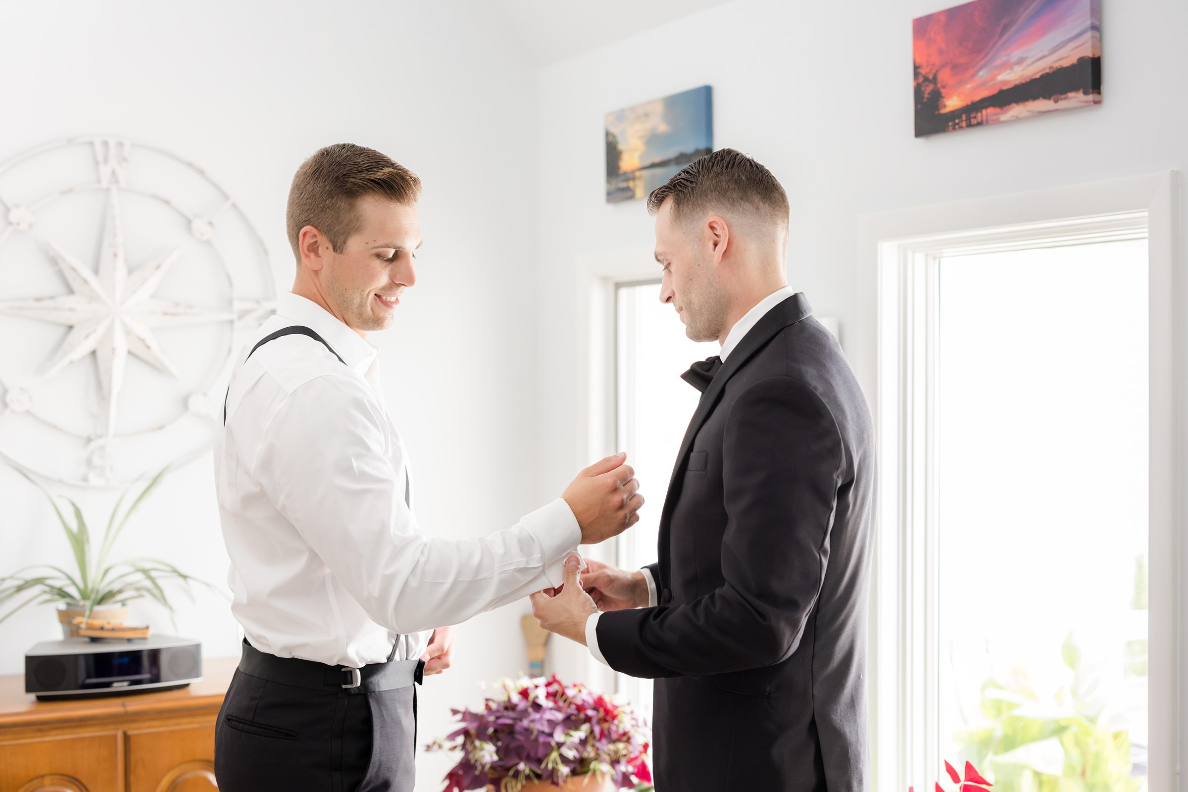 Groom shares a meaningful moment with his groomsman, preparing for the day that will change everything