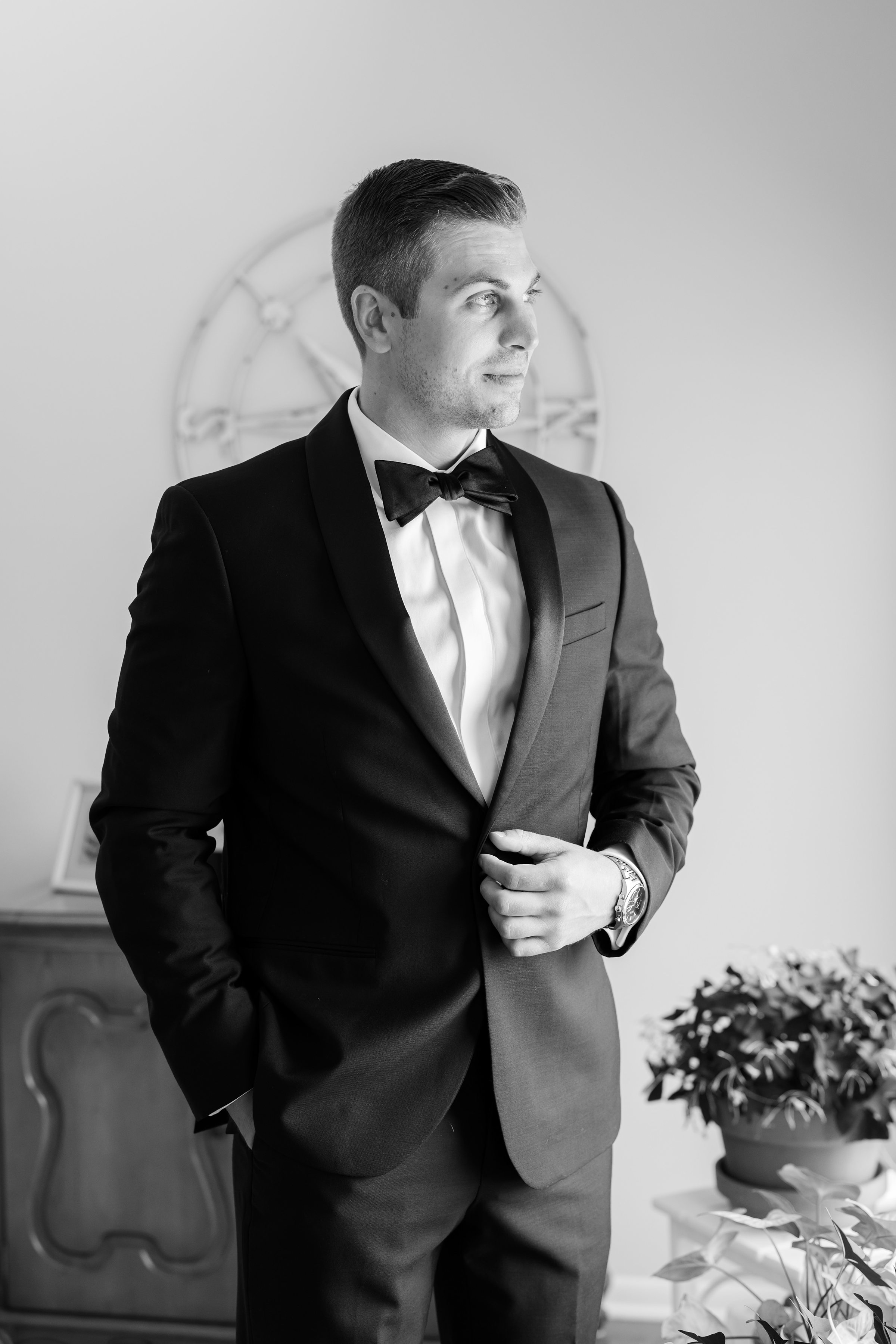 Groom stands poised and thoughtful, anticipation and love reflected in his quiet expression