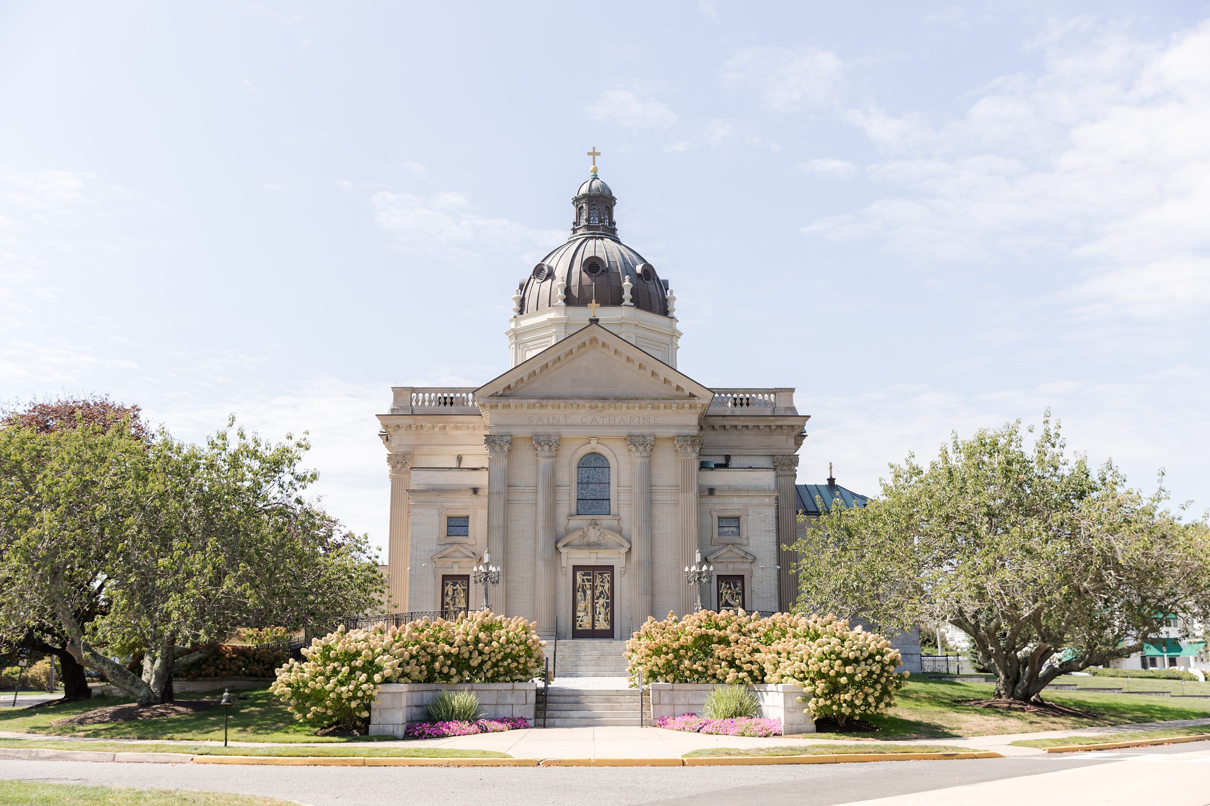 The grand church stands bathed in sunlight, a timeless backdrop for a love story just beginning.