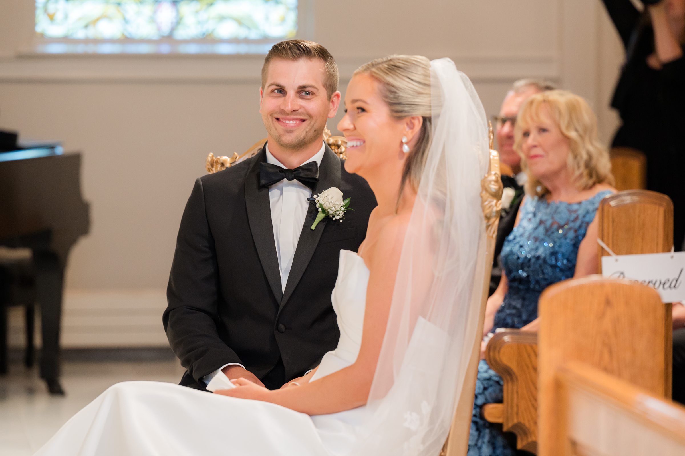 Groom gazes at his bride with a soft, adoring smile, capturing a moment filled with admiration and deep love