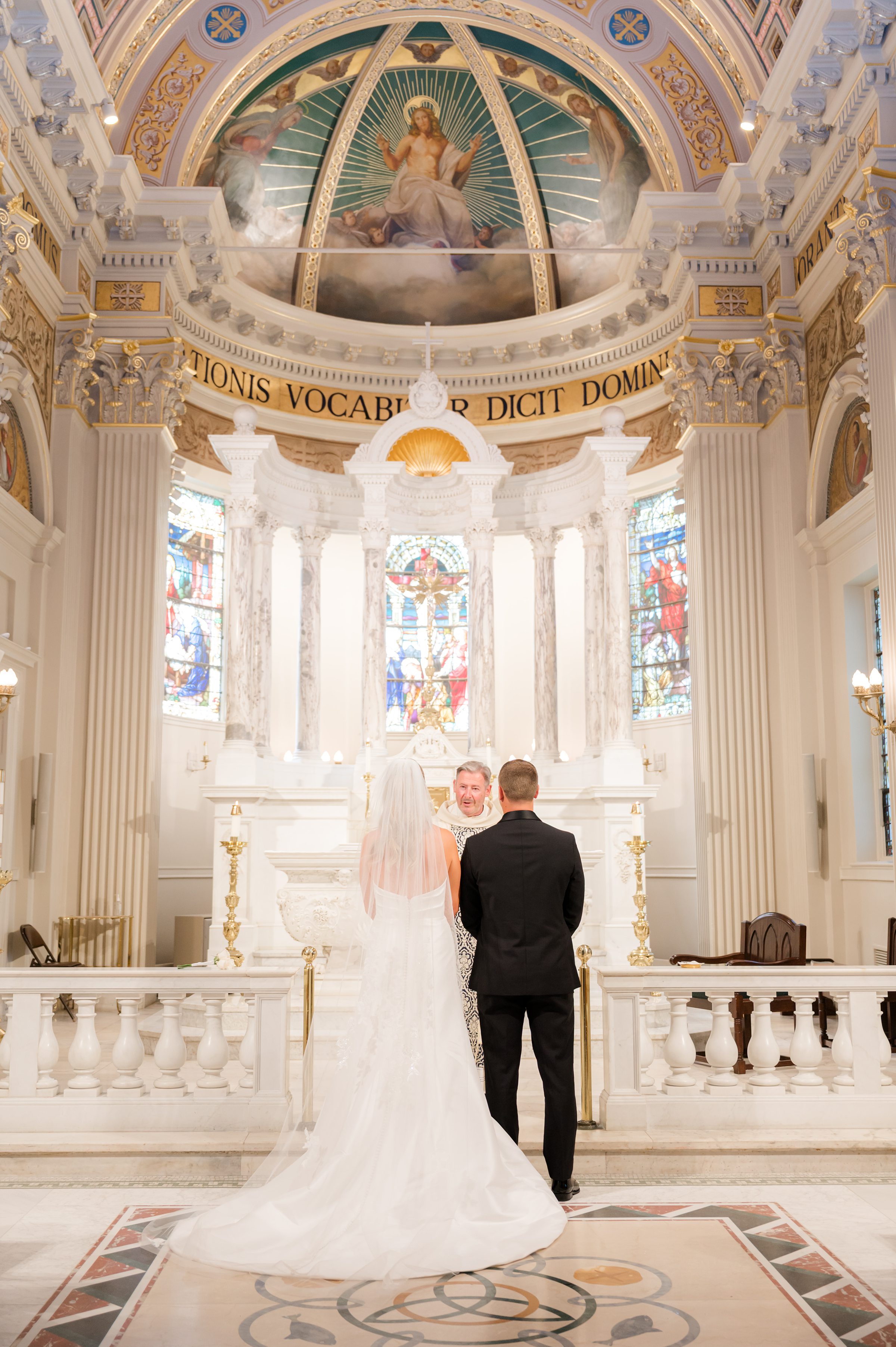 Bride and groom stand united at the altar, framed by glowing light and the promise of a shared future.