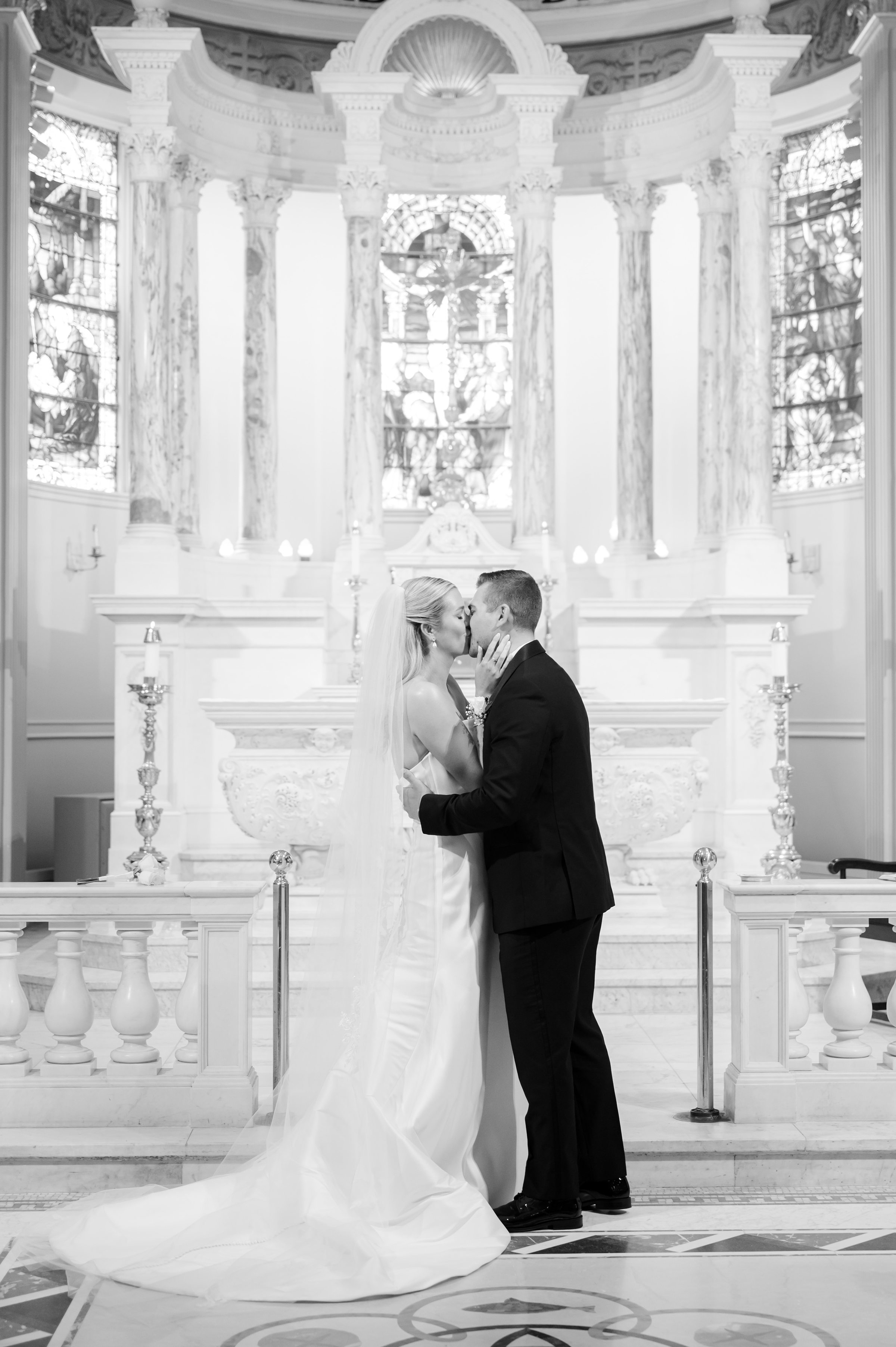 In a quiet, intimate moment at the altar, the couple shares a tender kiss, sealed in love and devotion