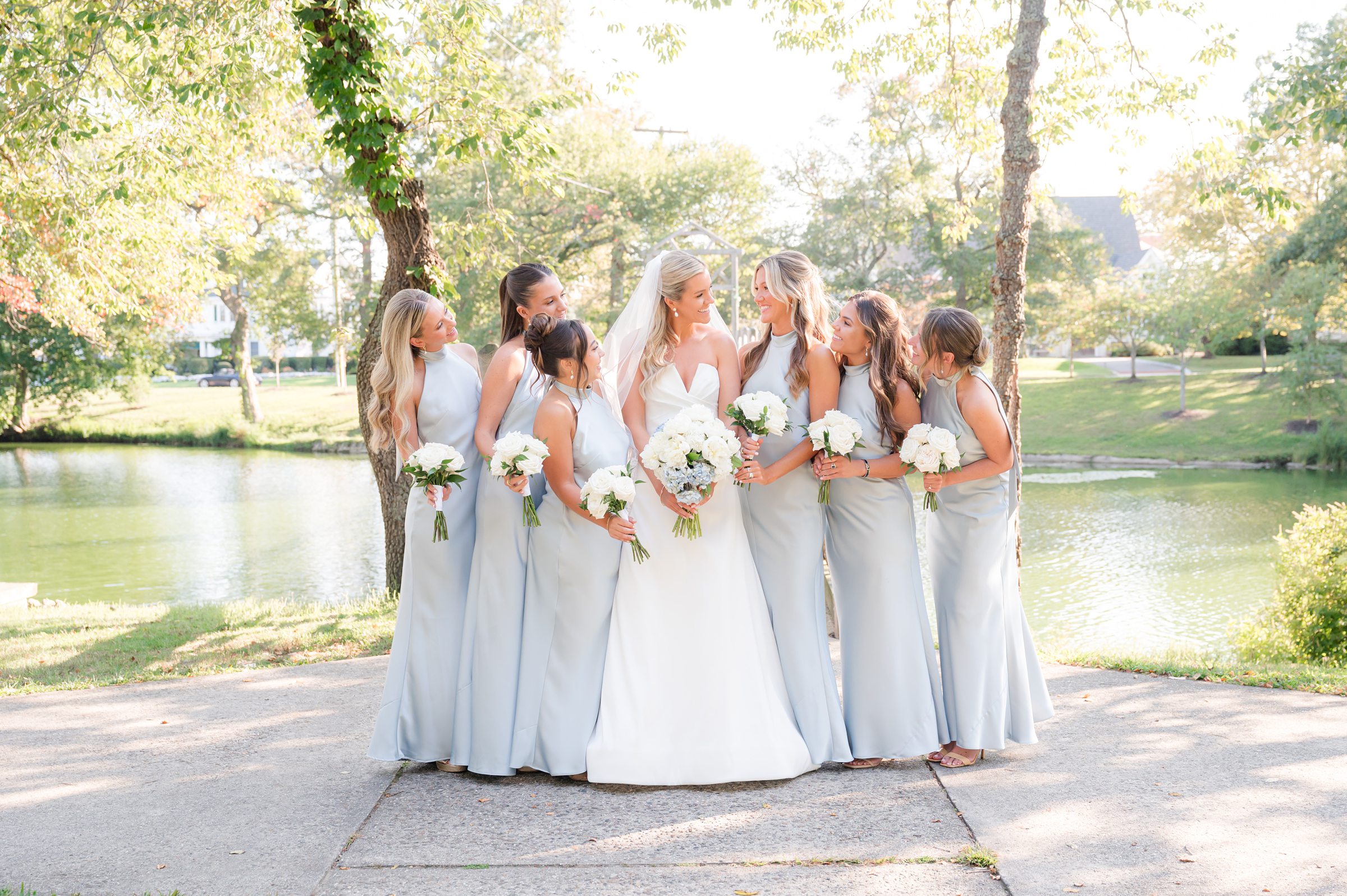 Bride stands surrounded by her bridesmaids, all glowing in soft light and joyful anticipation