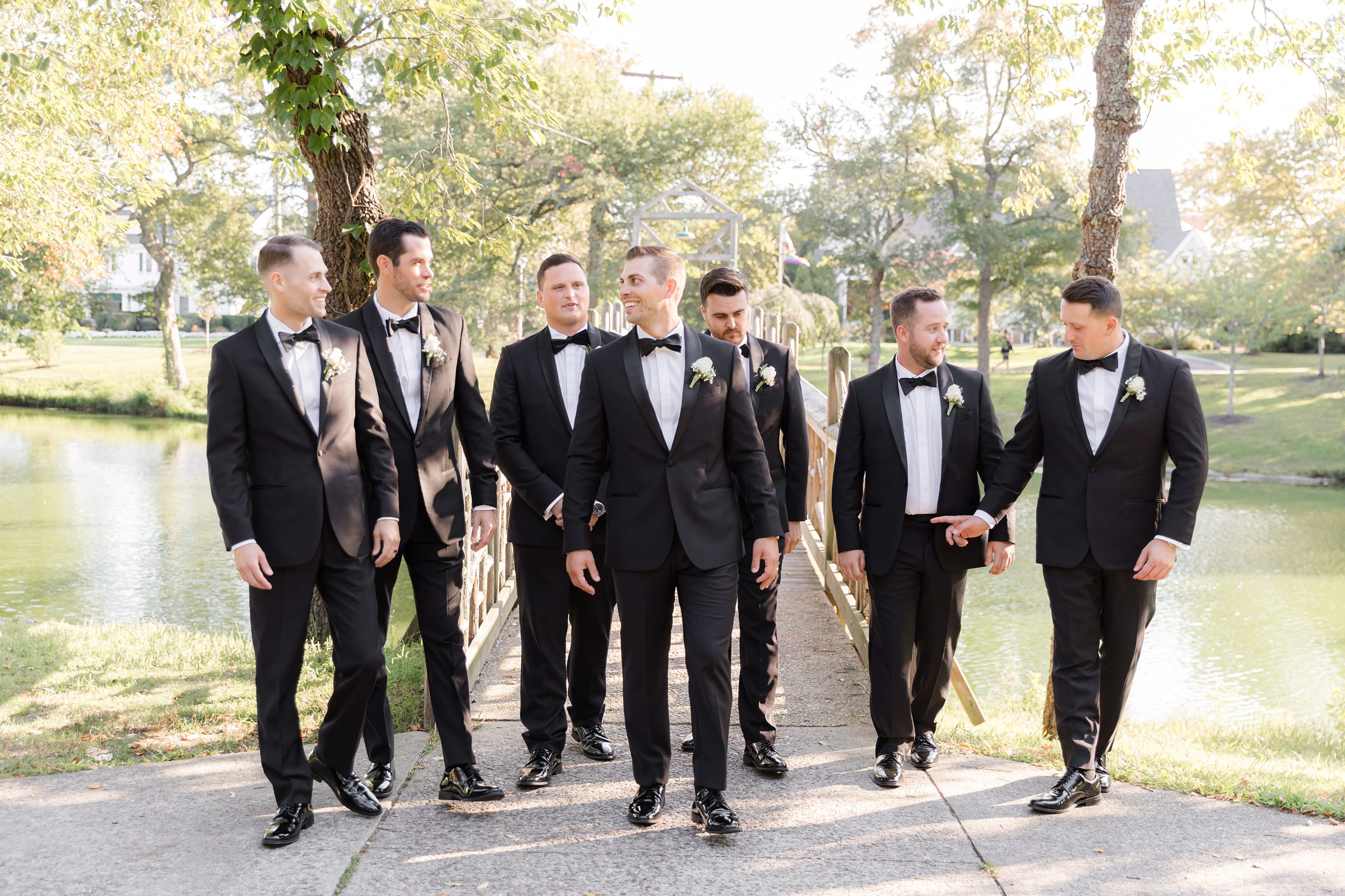 Groom walks confidently with his groomsmen, sharing laughter and anticipation before the celebration begins