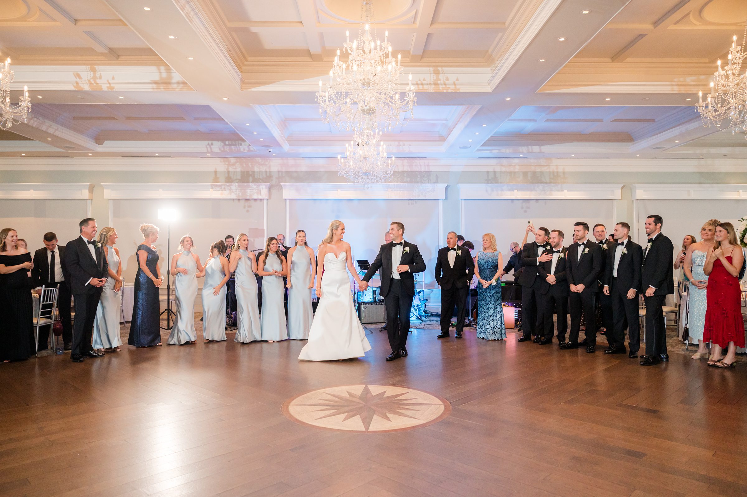 Bride and groom glides across the floor in a romantic dip, their connection radiating through every movement.
