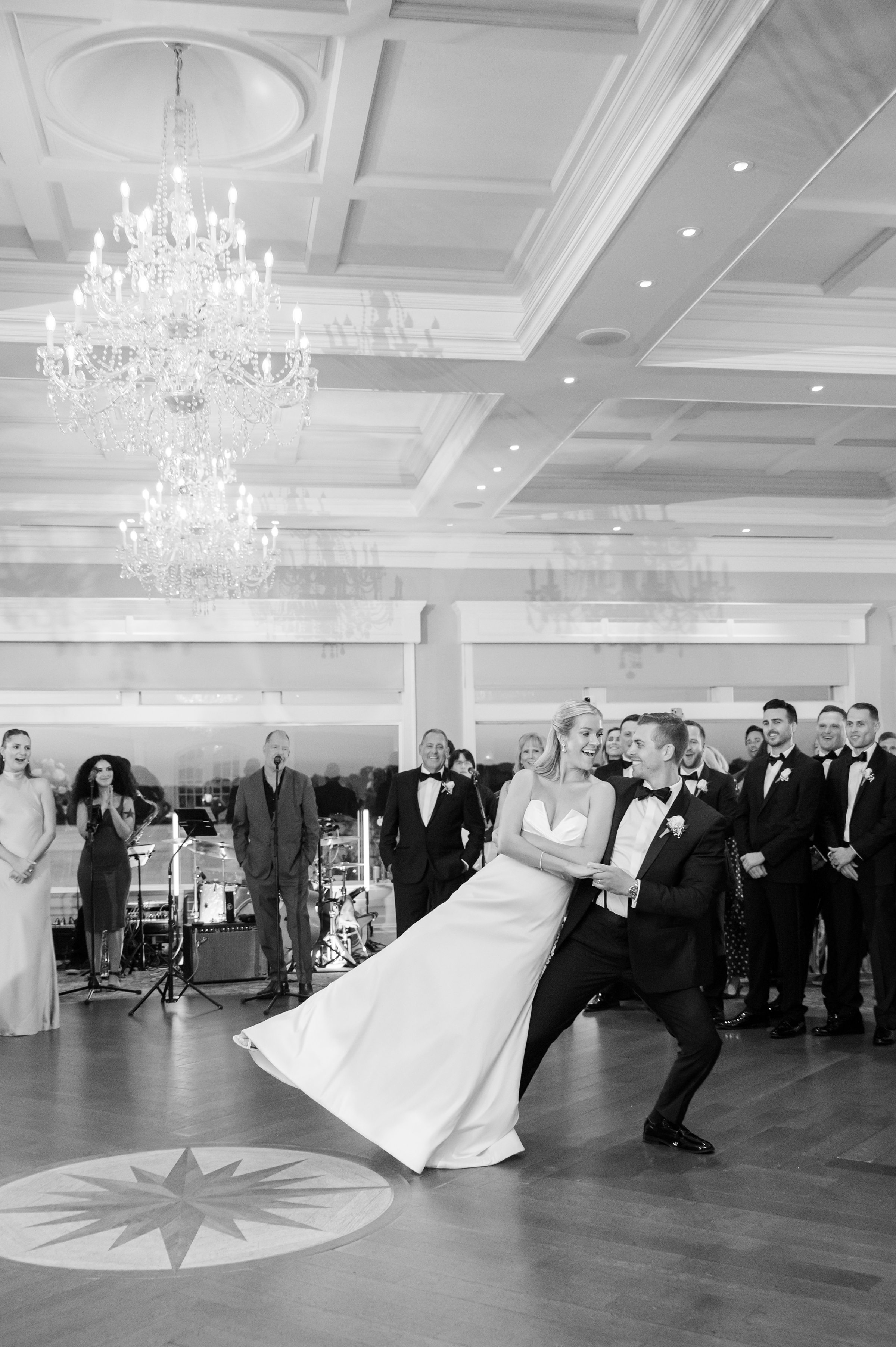 Groom lifts the bride effortlessly, her joy radiating as she reaches outward, trusting completely in him.