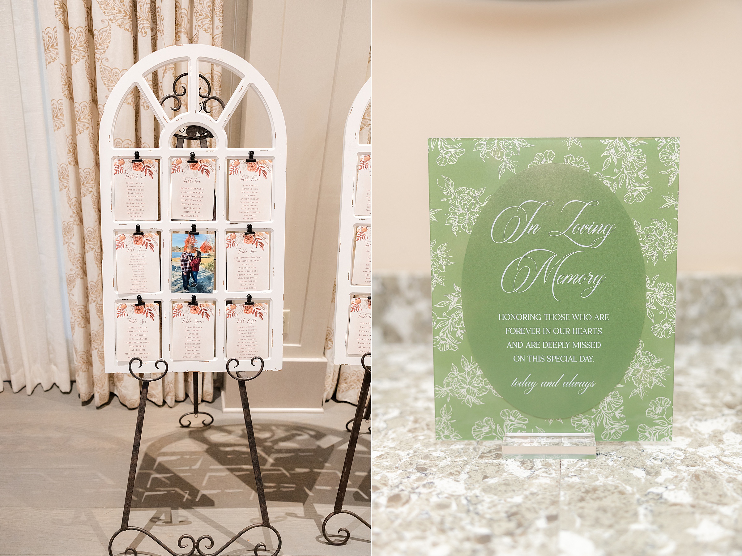 Wedding seating chart displayed on a decorative window frame with floral-accented cards and a couple’s photo, alongside a green “In Loving Memory” sign honoring loved ones on a marble surface