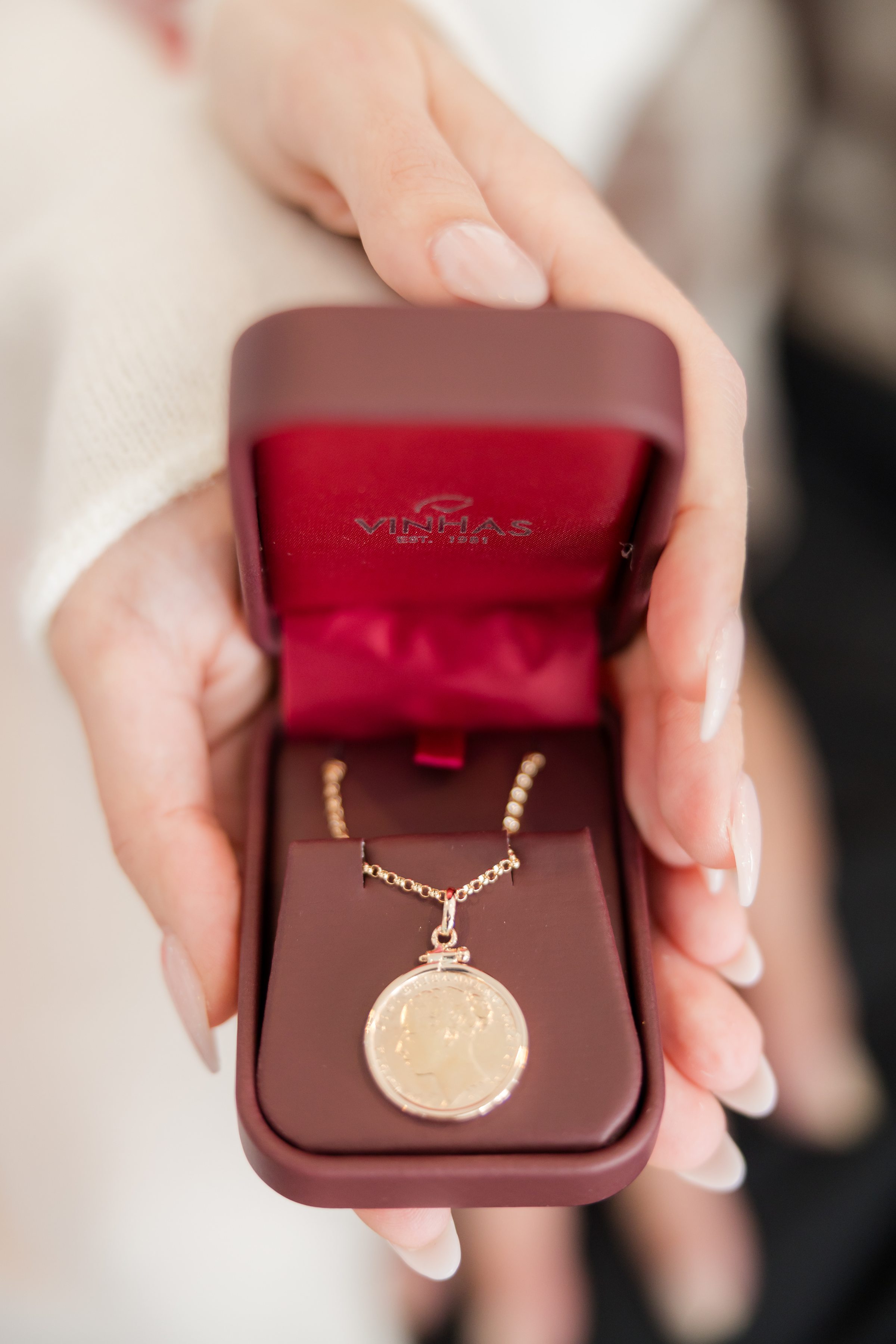Gold pendant necklace in a velvet lined box, a meaningful gift for the wedding day.