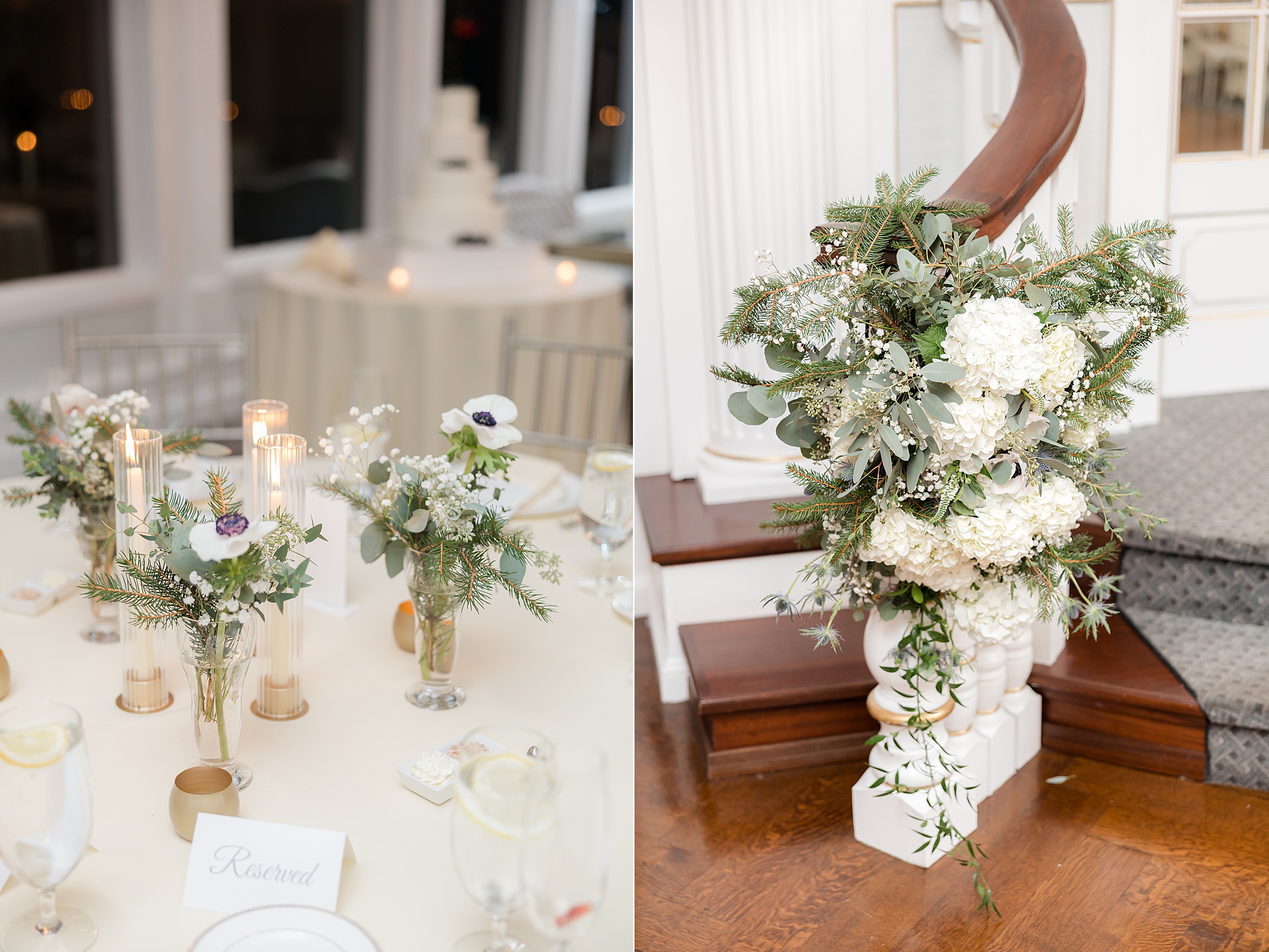 Wedding reception table with candles and small floral arrangements next to a large white and green floral display on a staircase.