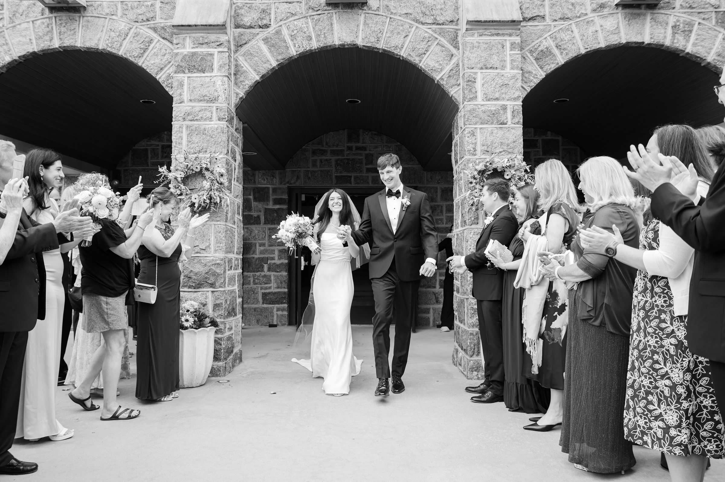 Bride and groom walk forward together as husband and wife, embraced by joyful applause and the promise of forever.
