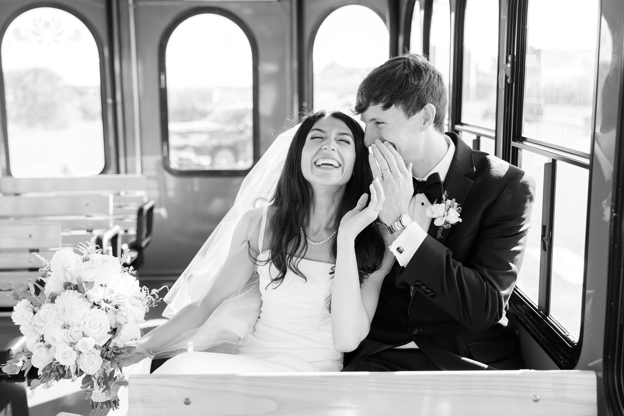 Newlyweds share a secret laugh, wrapped in joy and soft light, as they begin their forever together.