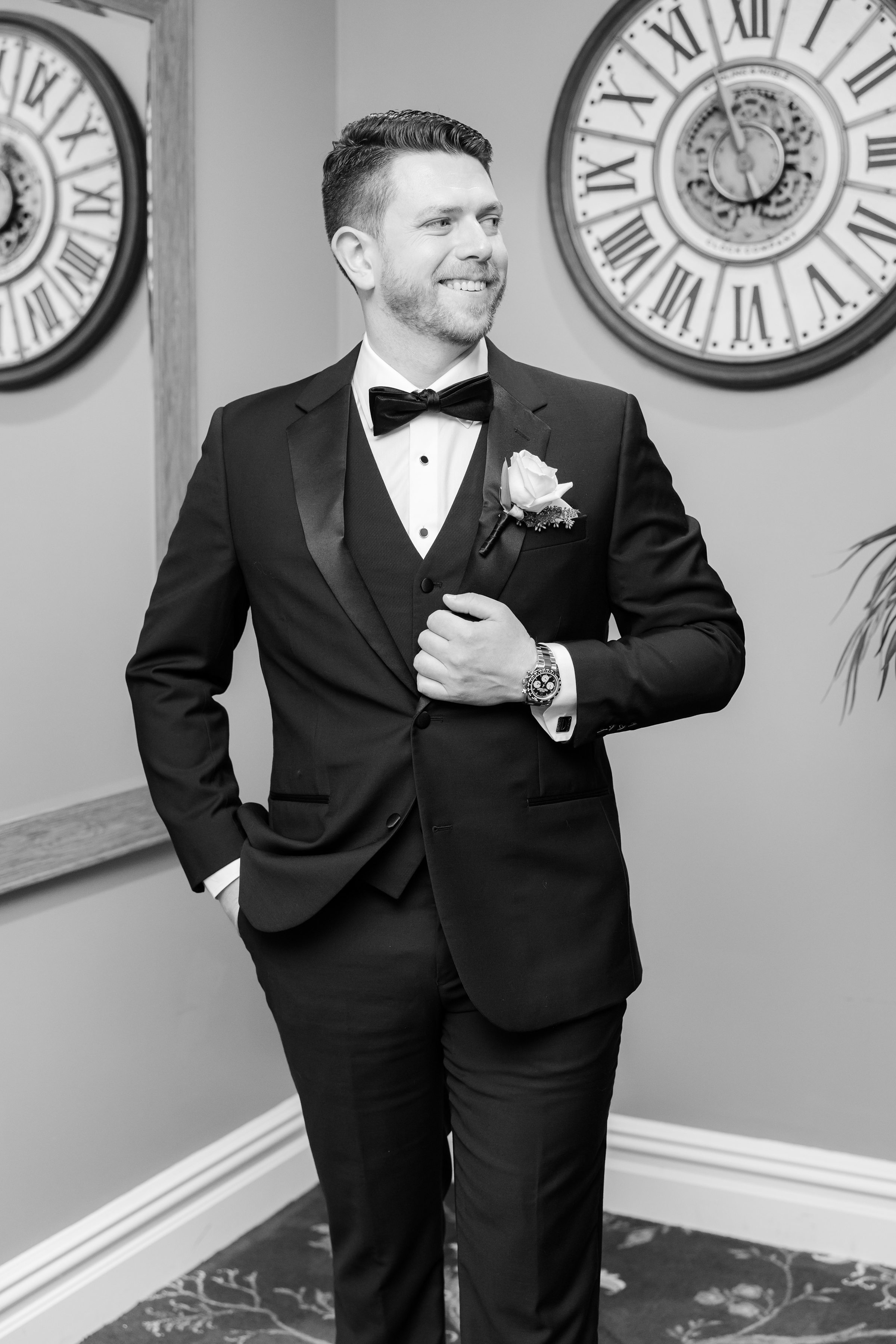 Groom smiling confidently in his tuxedo before the ceremony.