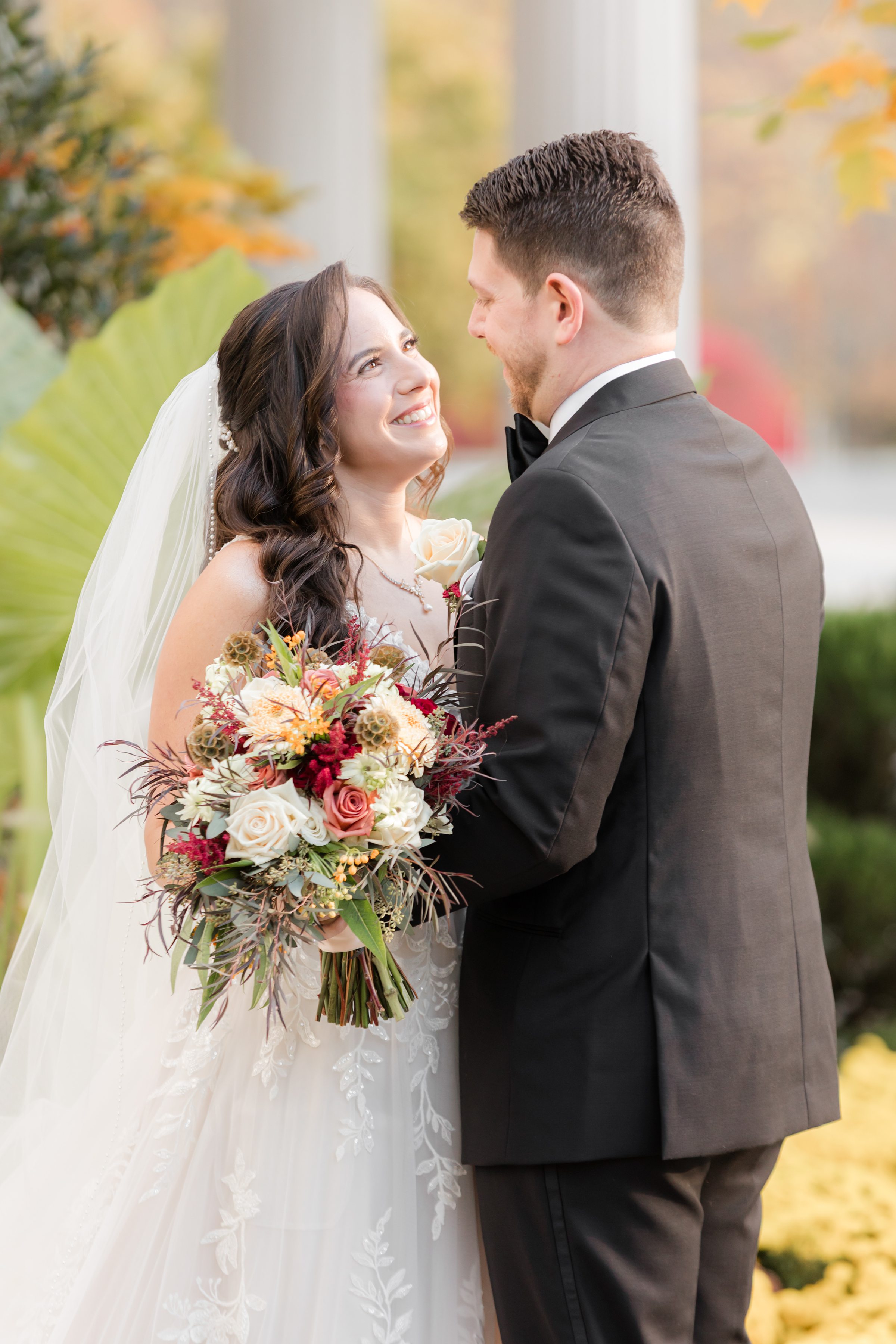 Bride and groom gazing into each other’s eyes, smiling with joy and love.