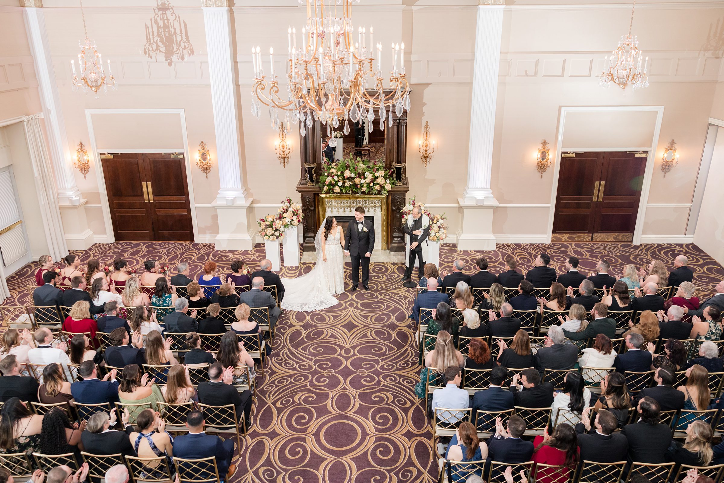 Bride and groom stand together at the altar, sharing a heartfelt moment as they begin their life together surrounded by loved ones