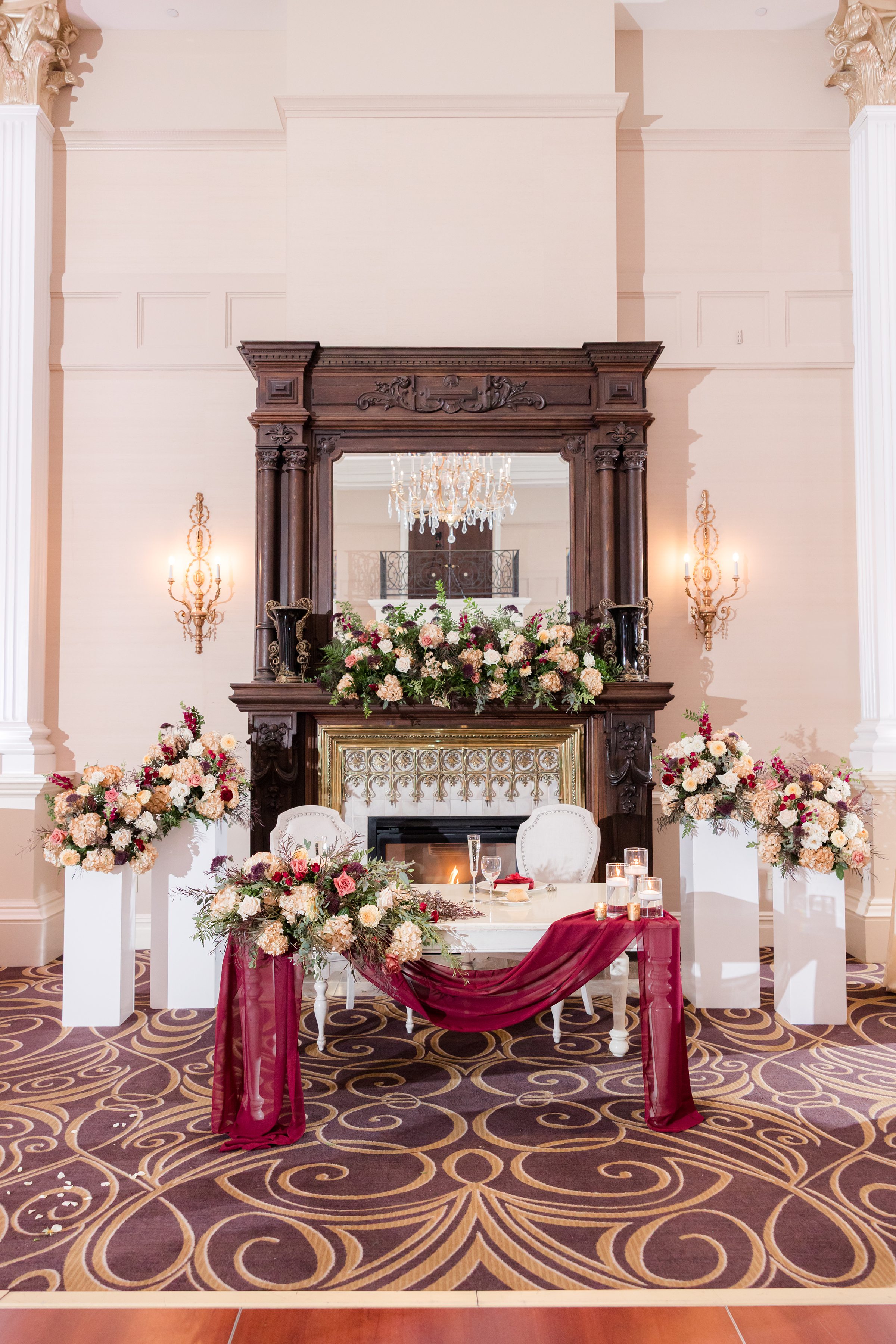 Lush floral centerpiece with glowing candles, adding warmth and romance to the reception ambiance