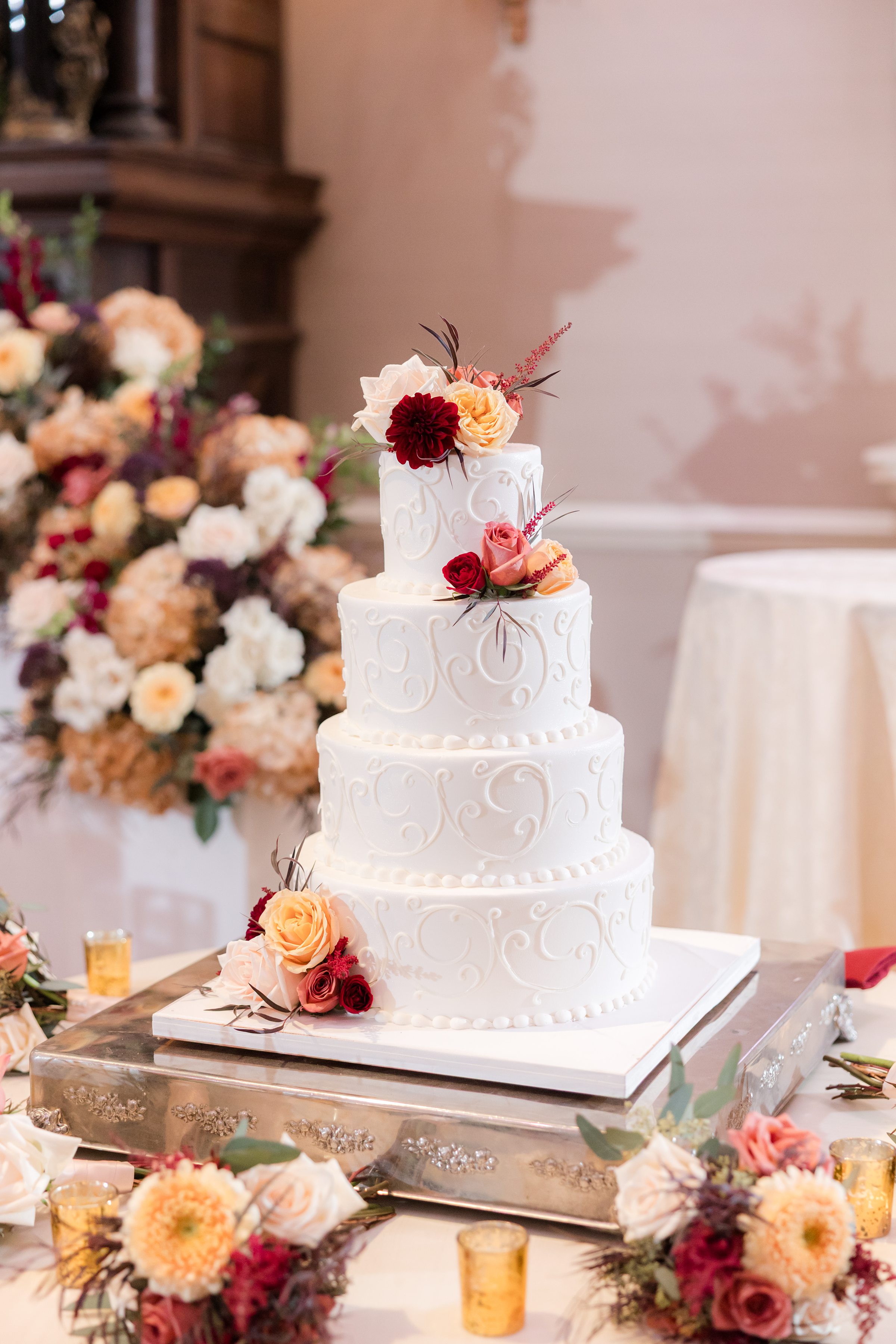 Delicate white wedding cake adorned with fresh blooms, embodying timeless romance and refined elegance