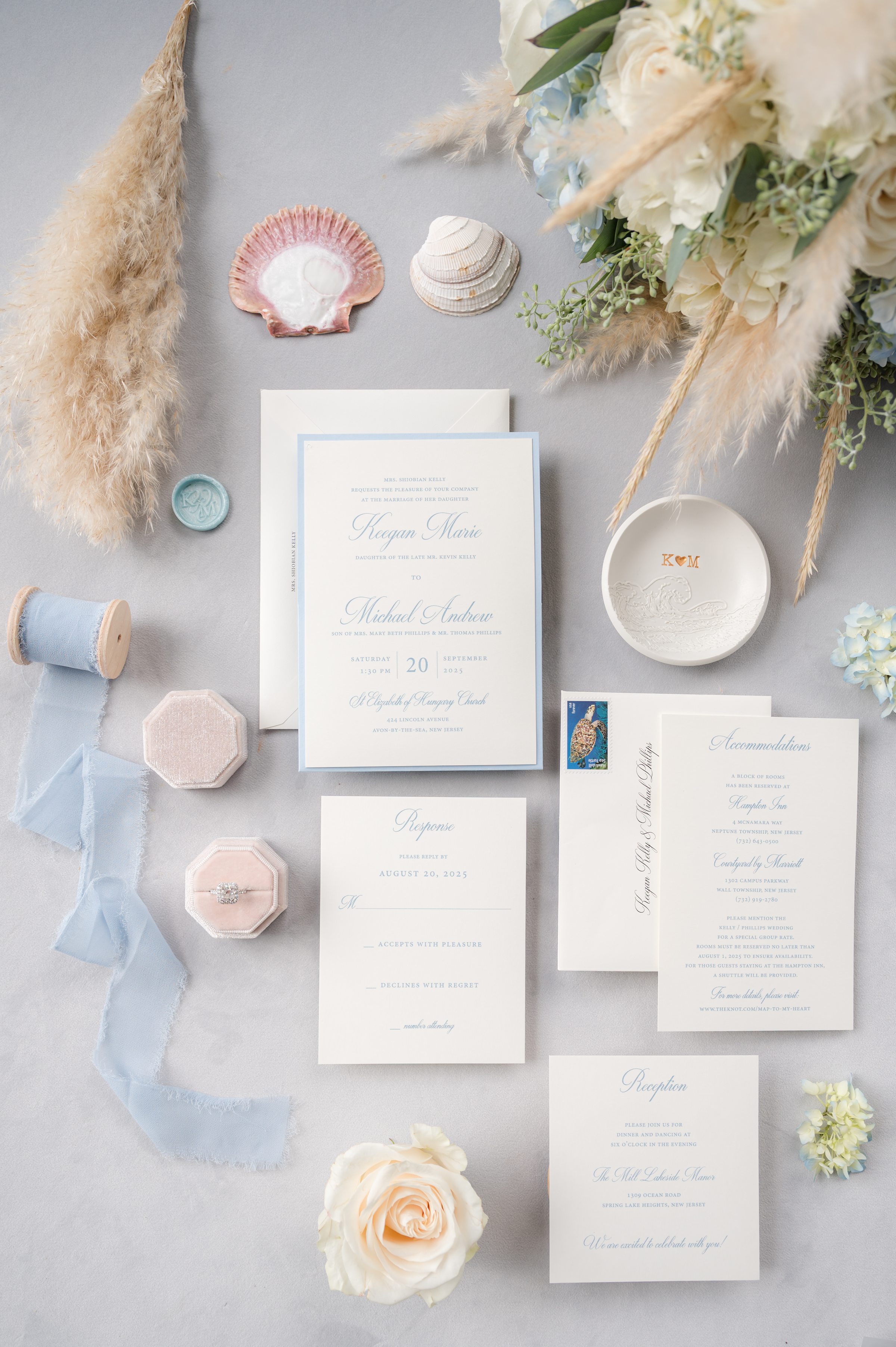 Beautifully styled invitation suite surrounded by flowers, heirloom details, and meaningful keepsakes.