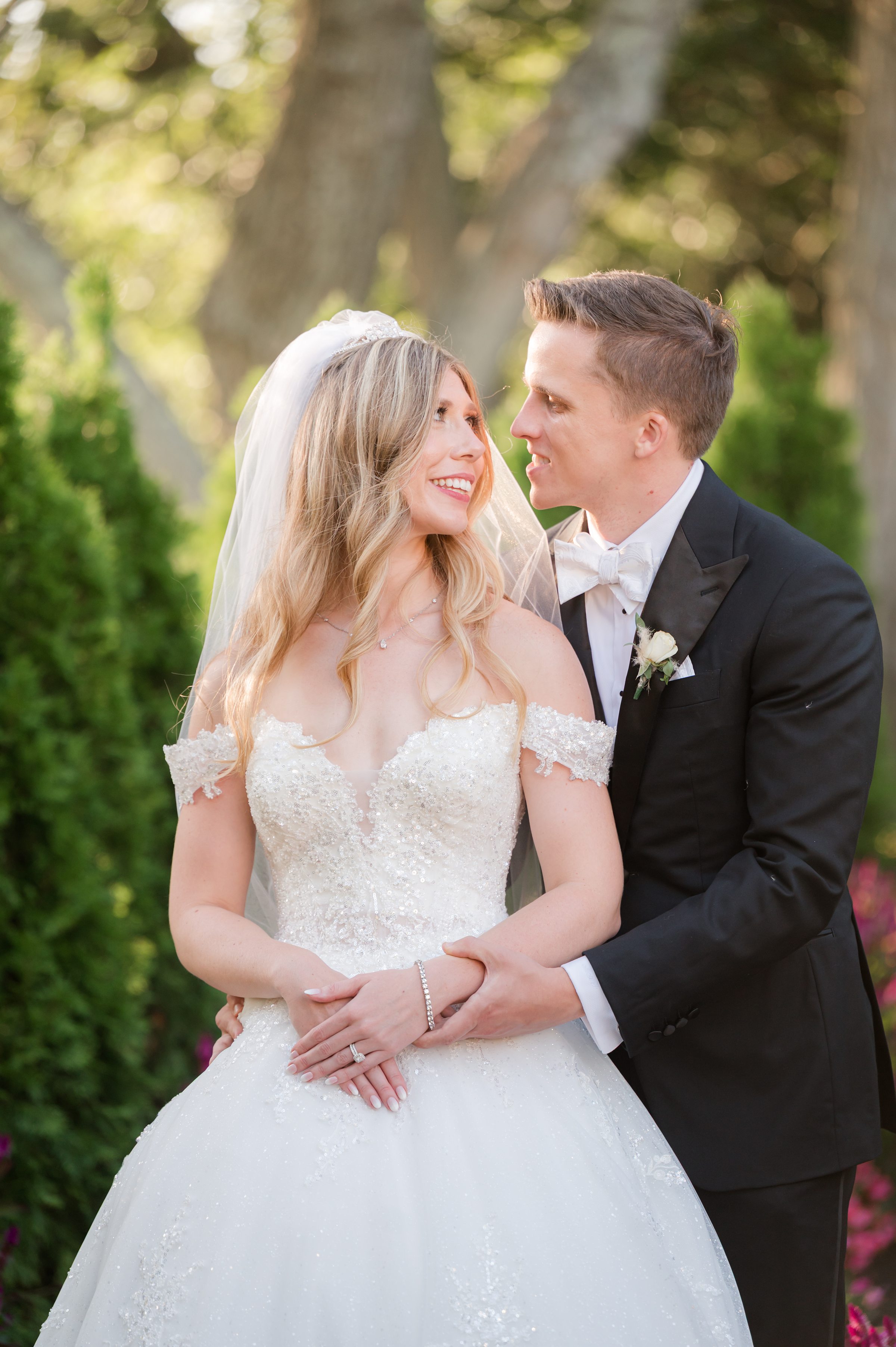 Bride and groom gazing into each other’s eyes, smiling with pure joy and love.