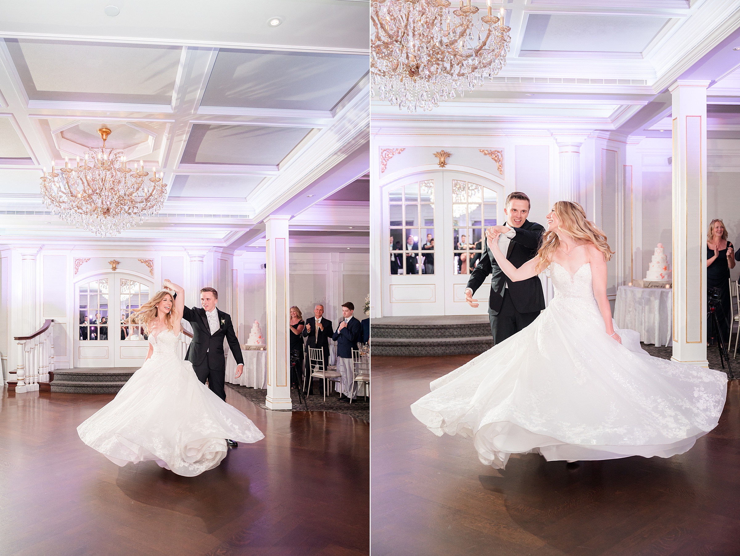 Bride and groom dancing in a grand ballroom, with the bride twirling in her flowing gown under chandeliers and soft purple lighting as guests watch in the background.