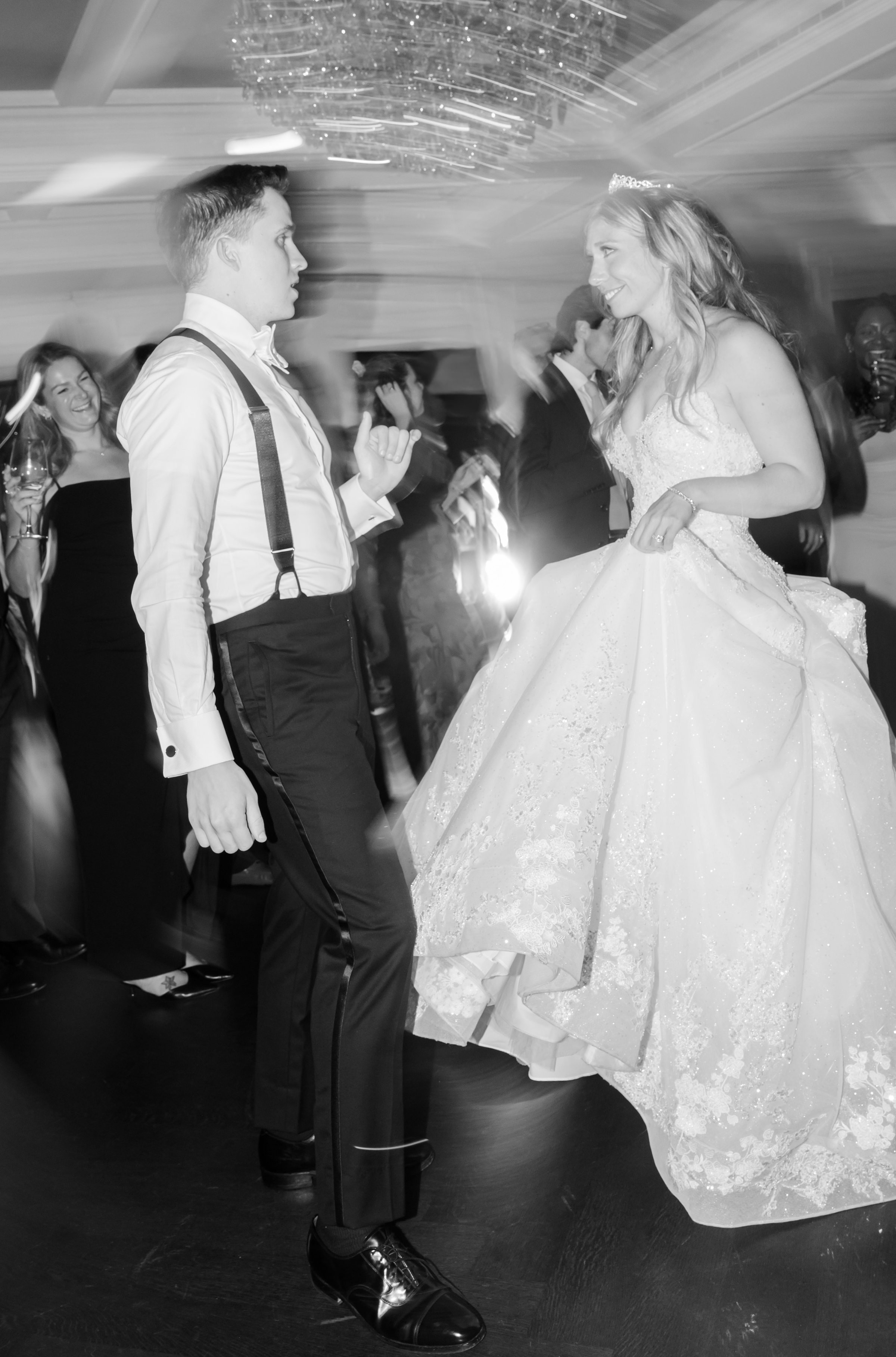 Bride and groom dance together with motion blur, creating a dynamic, energetic effect.