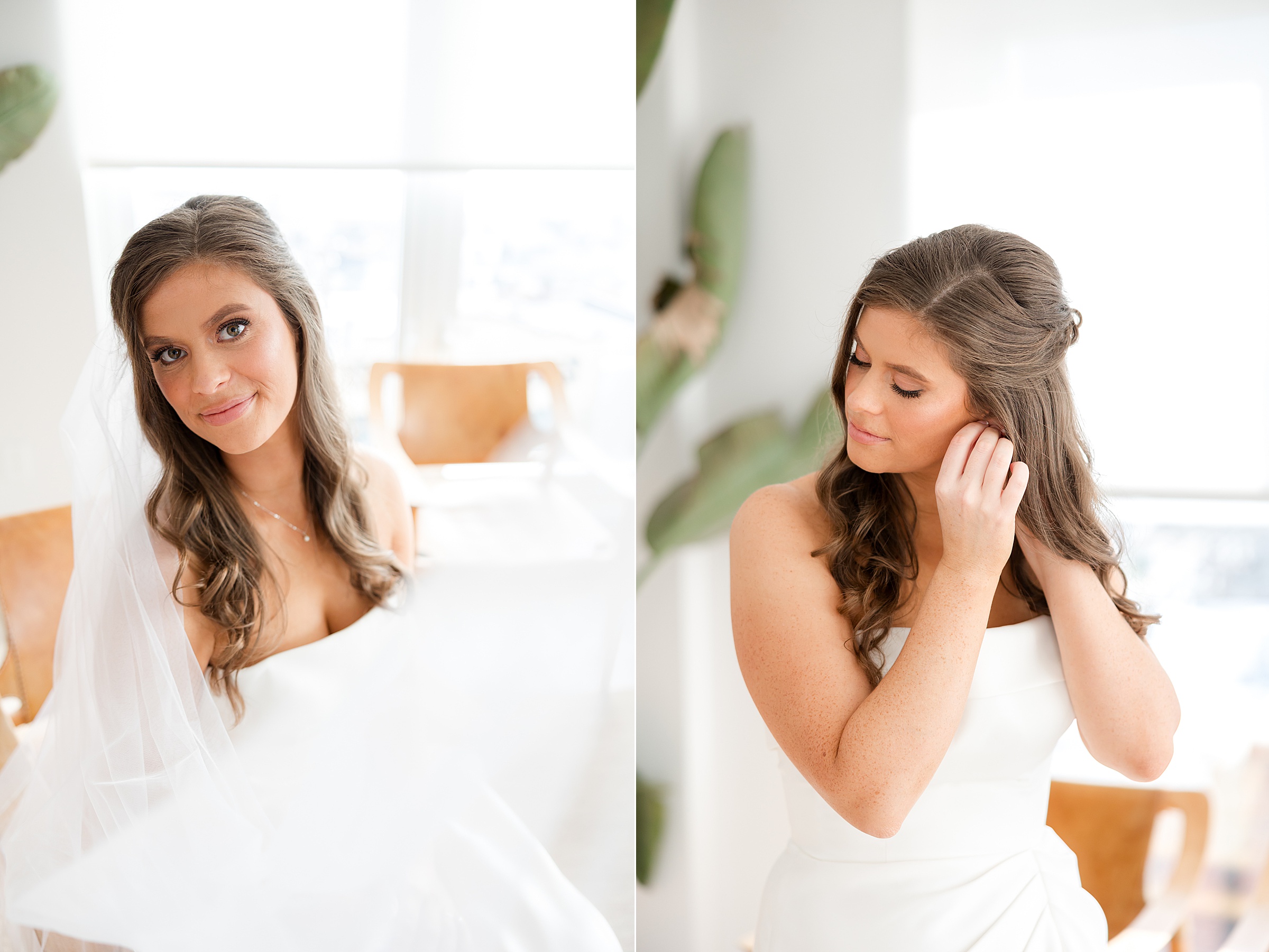 Bride in a strapless wedding dress and veil smiling softly and adjusting her earring in a bright, natural light filled room.