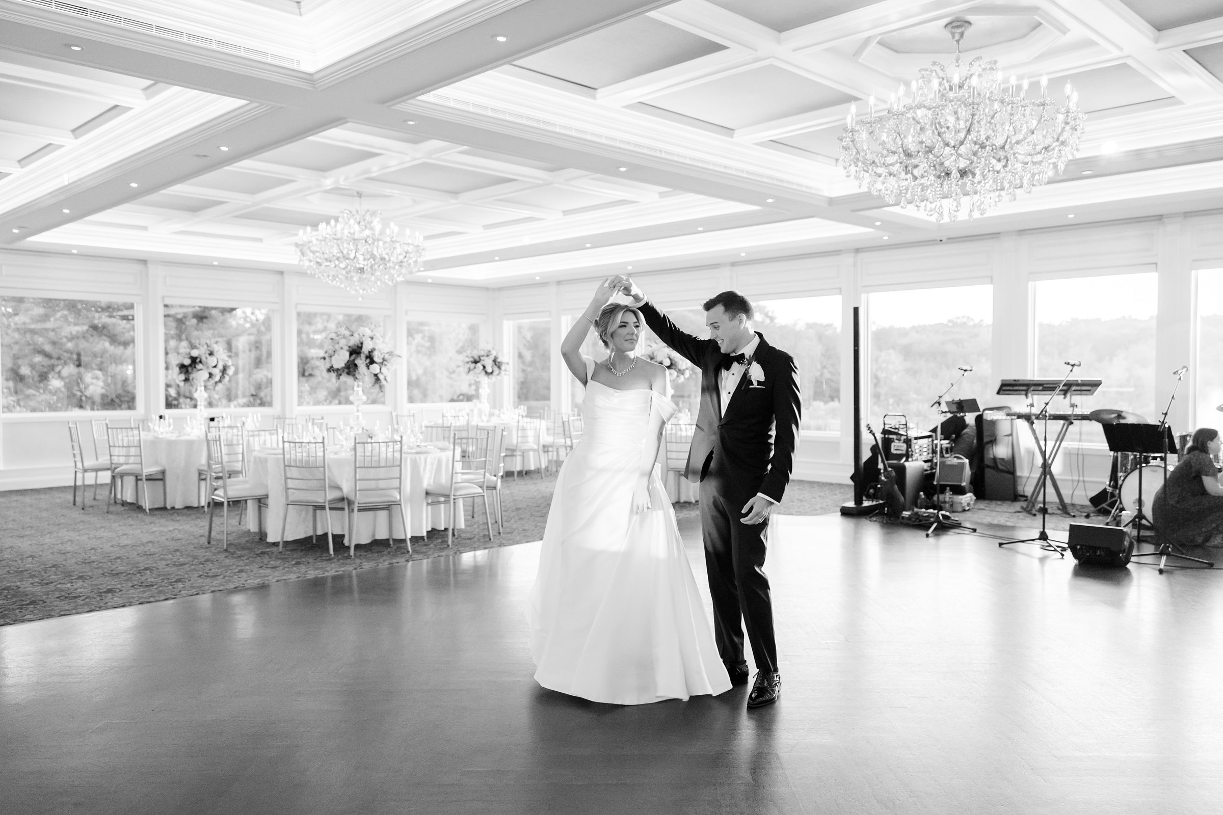 Bride and groom shares a quiet dance in a sunlit room, their movements gentle and connected, reflecting their deep love.