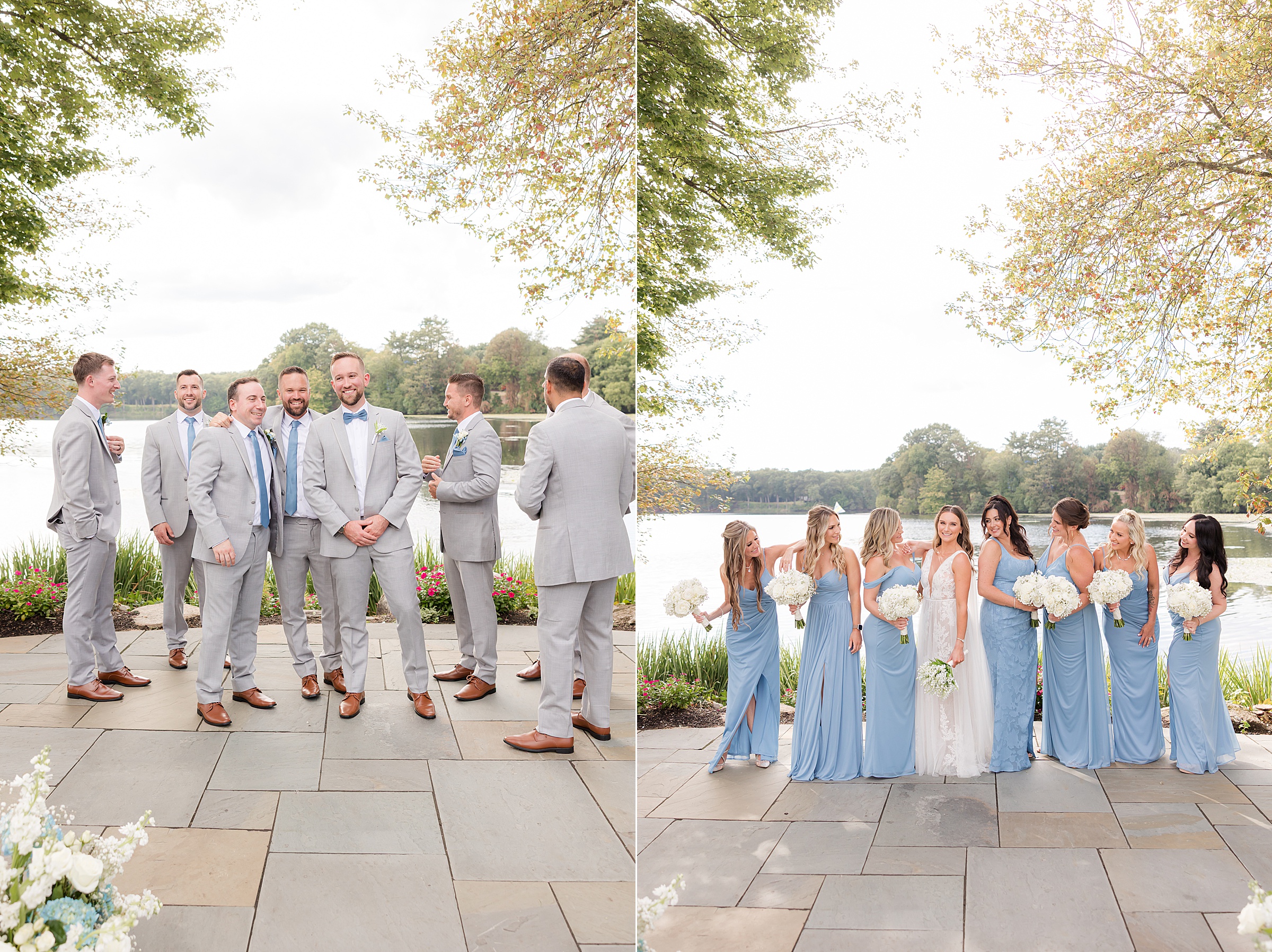 Bride and groom stand at the heart of their wedding party, surrounded by loved ones in soft blue and gray, as golden sunlight filters through the trees and reflects off the water, capturing a moment of pure joy and togetherness