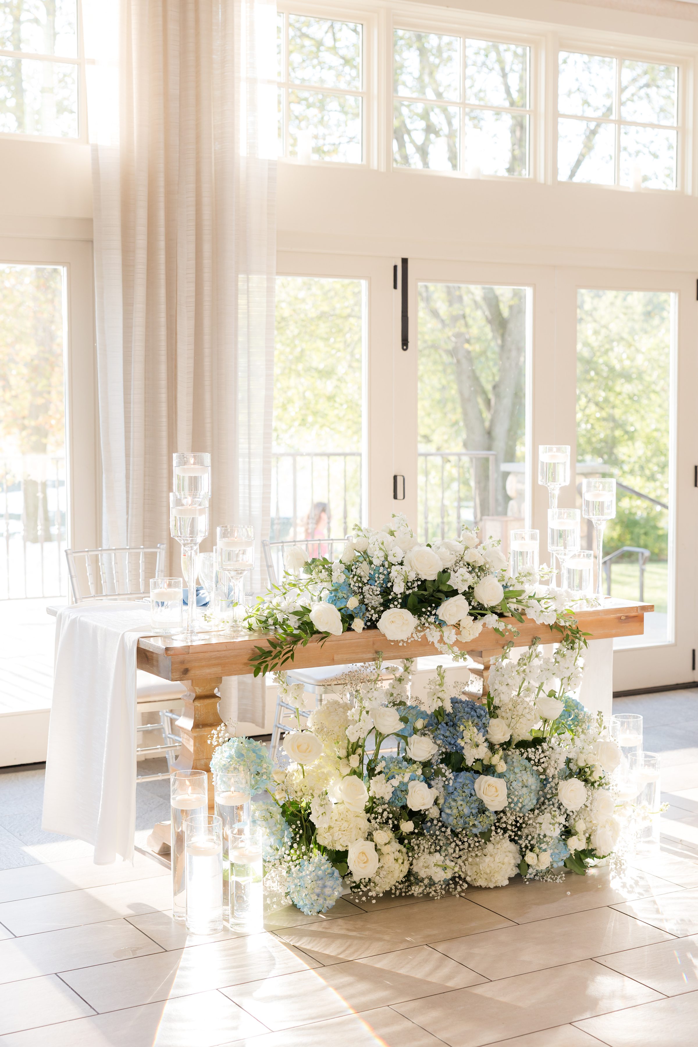 Sweetheart table blooms with soft florals and candlelight, a beautiful space reserved for the newlyweds