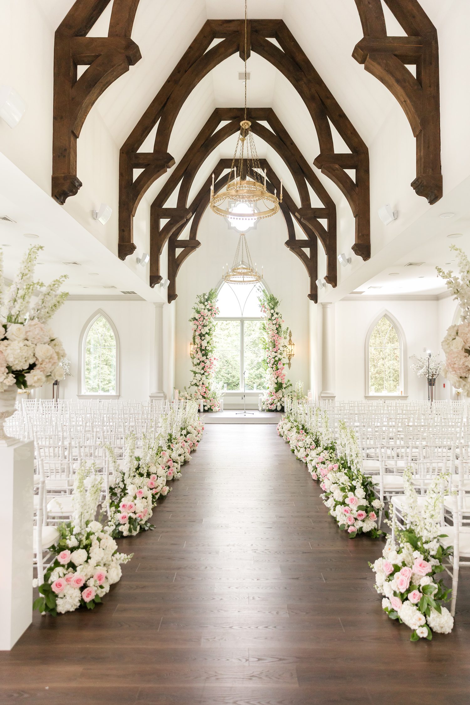 Wedding venue featuring an intricate floral details along the aisle and at the altar at Park Chateau Estate ceremony space