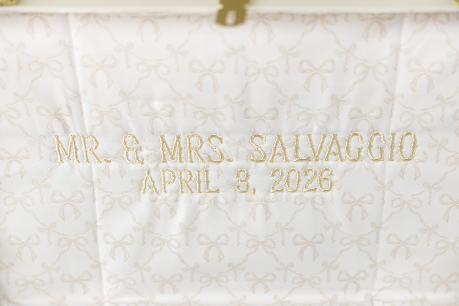 Luxury wedding invitation card with gold embossed lettering and soft neutral tones