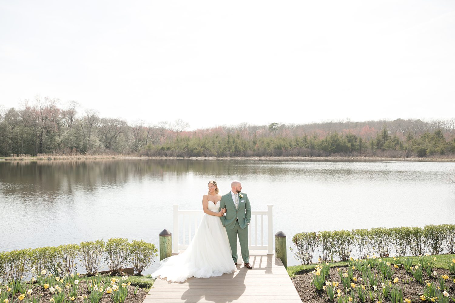 Elegant wedding couple portrait with panoramic lakeside landscape background