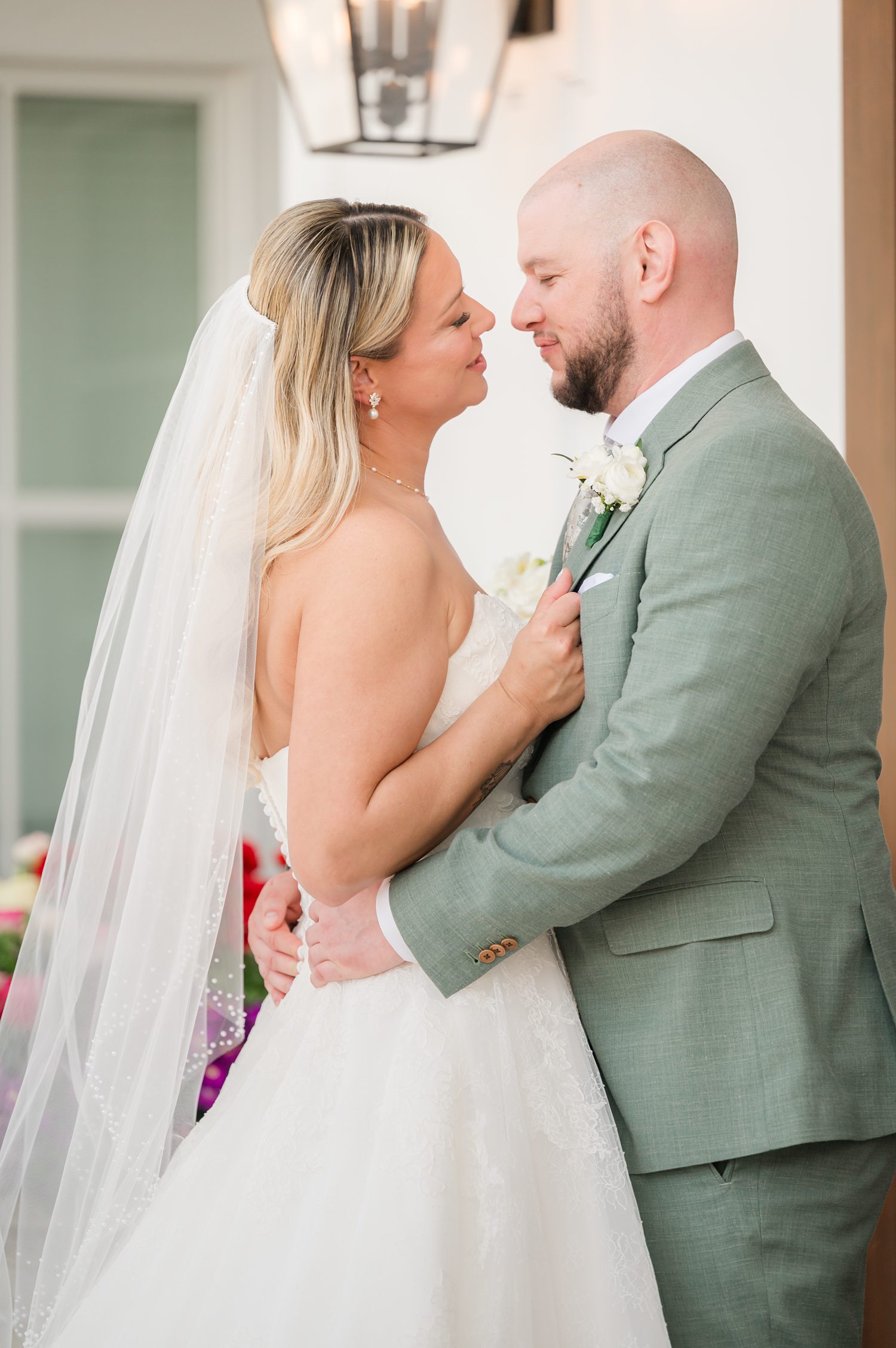 Bride and groom embracing closely during intimate wedding portrait session