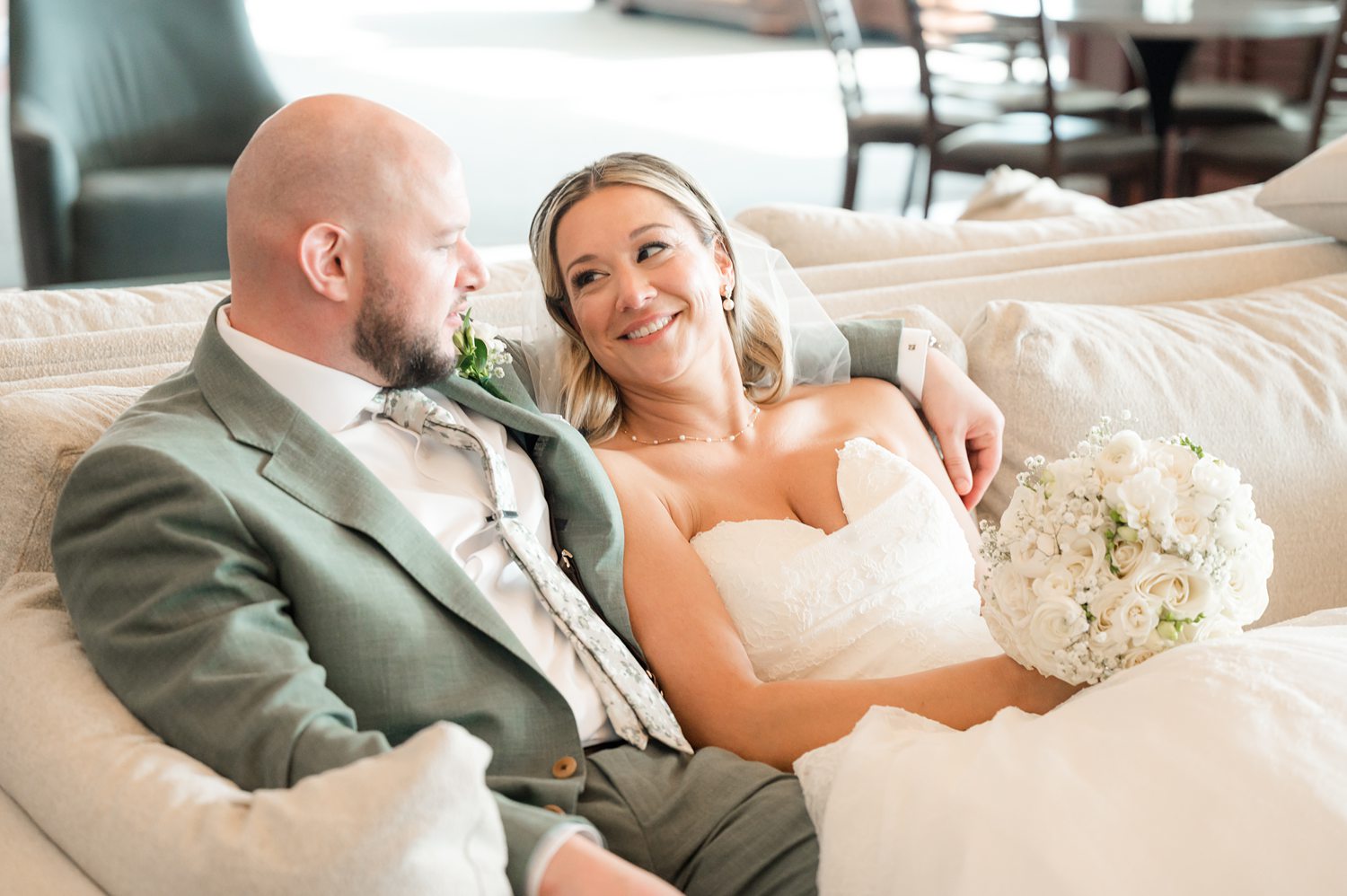Romantic newlywed couple relaxing together indoors after wedding ceremony