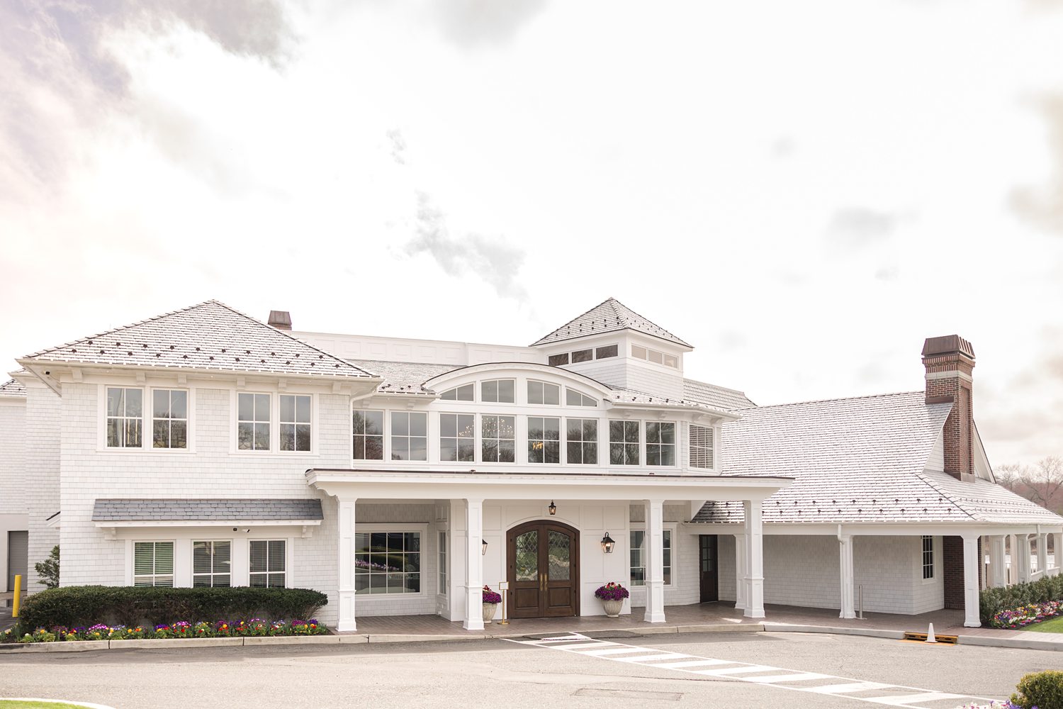 Elegant white lakeside manor wedding venue exterior with luxury architecture