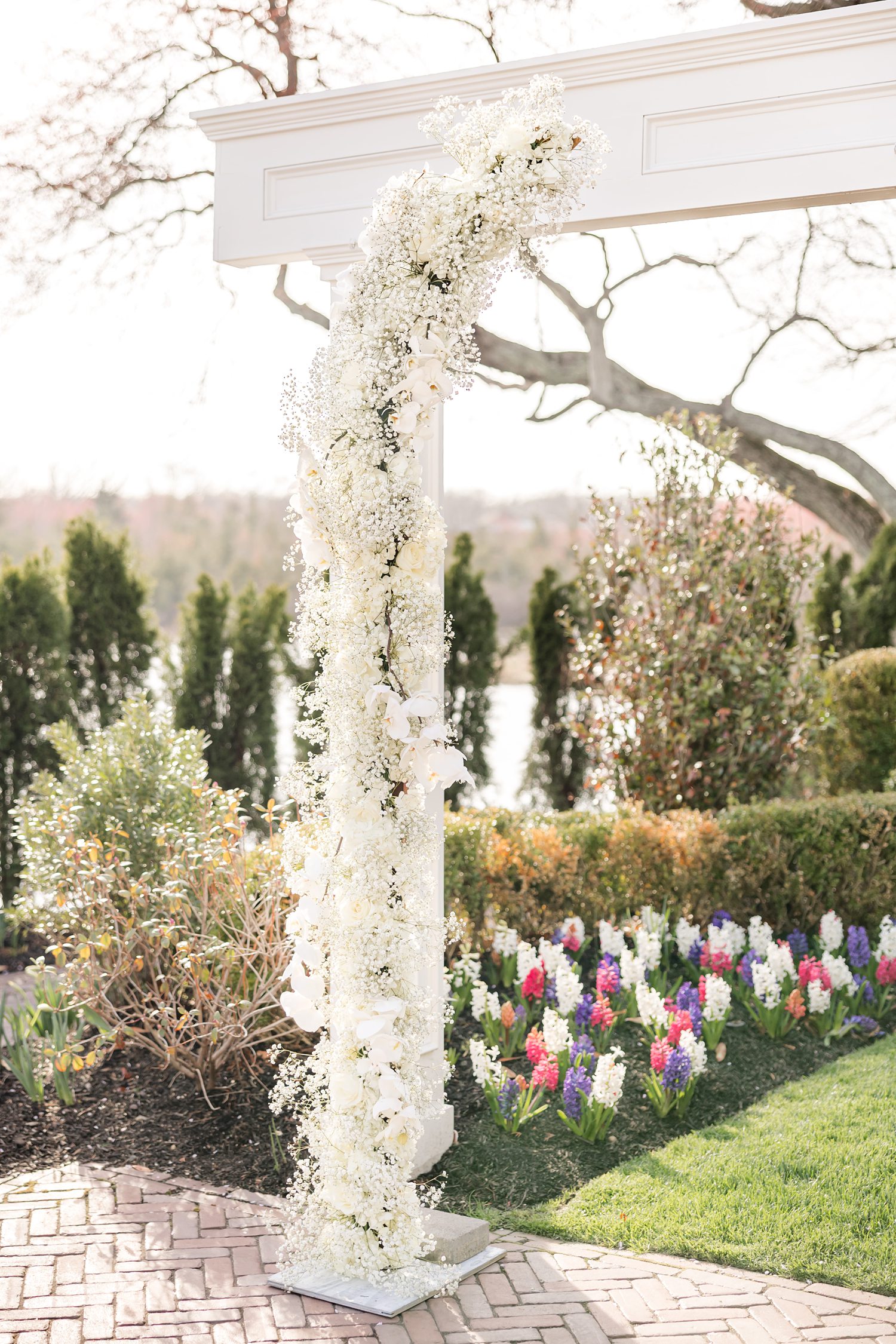 Romantic floral wedding arch with white roses in outdoor garden venue