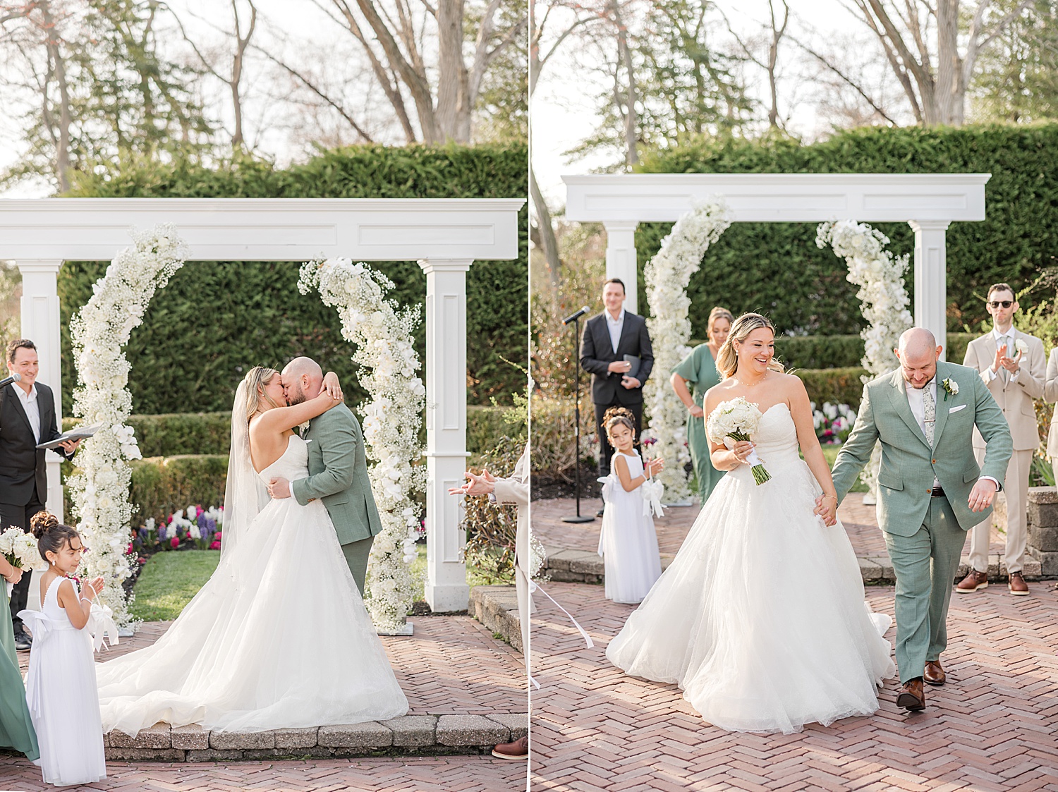 Bride and groom exchanging vows and kisses beneath white floral wedding arbor
