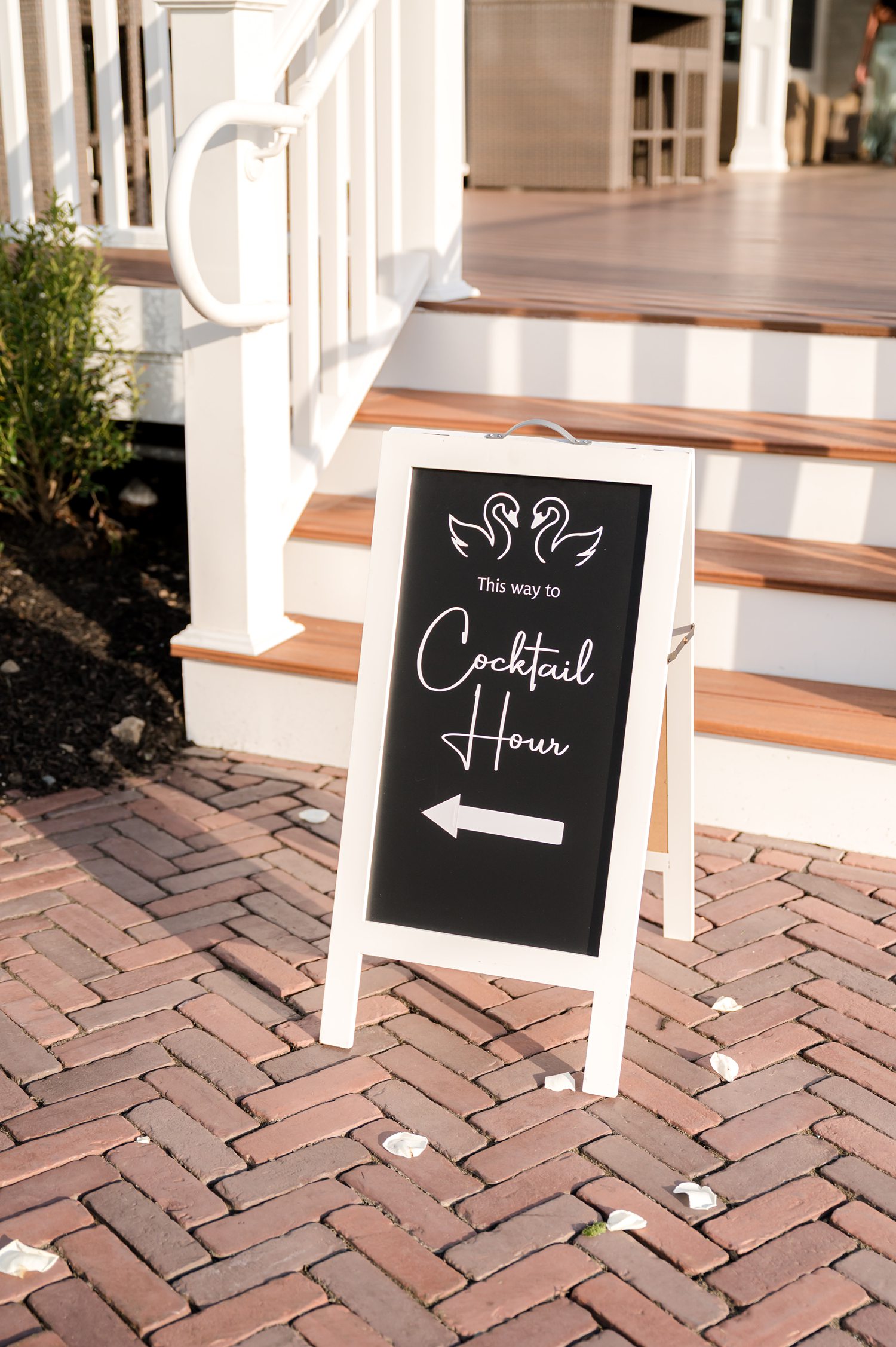 Elegant wedding welcome sign displayed on brick entrance walkway