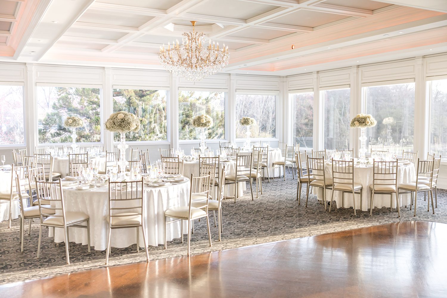Luxury wedding reception ballroom with elegant tables and floral centerpieces