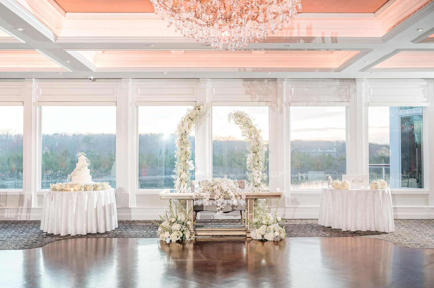 Elegant wedding sweetheart table with panoramic windows and romantic decor